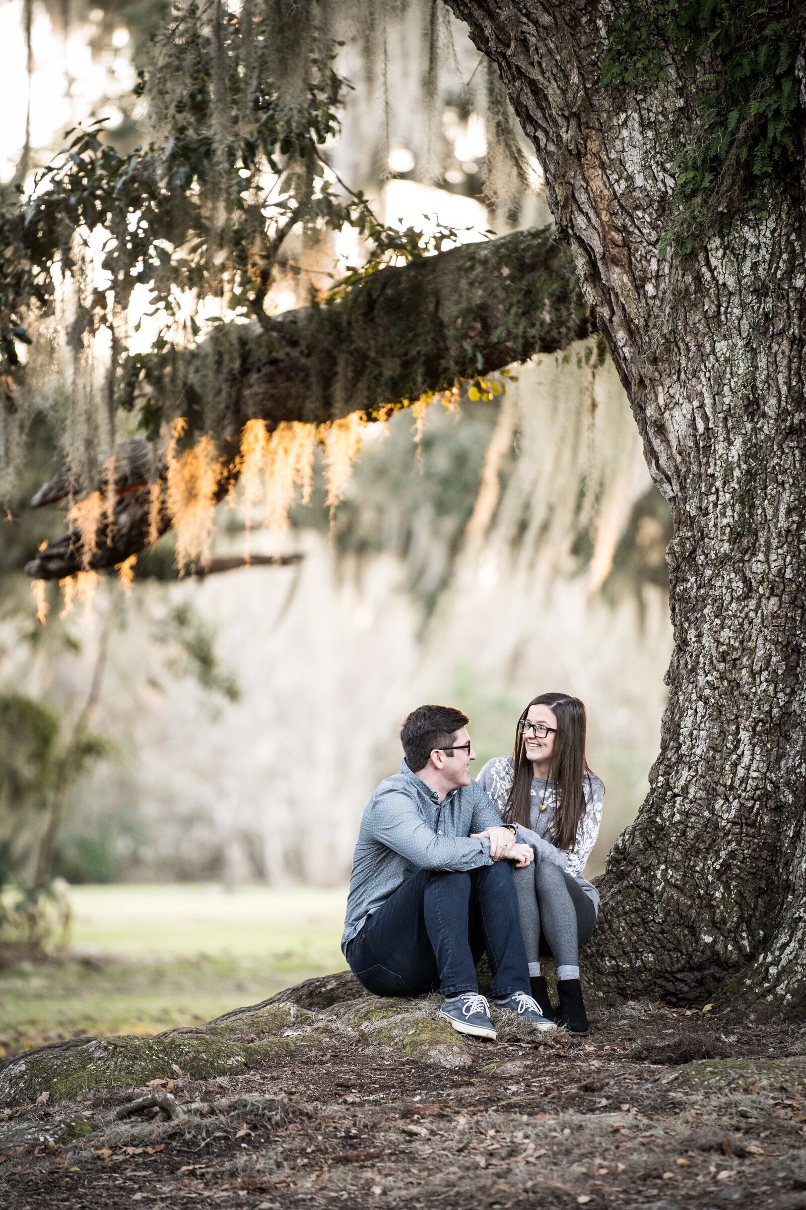 Couple sitting by tree at Fontainebleau State Park in Mandeville