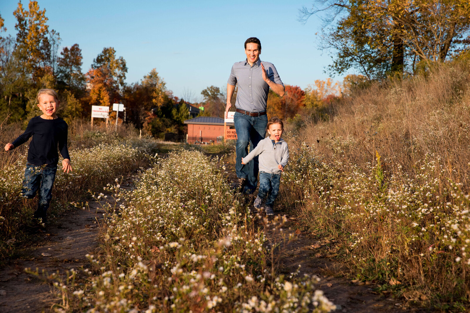 Young sons race father along conservation trail