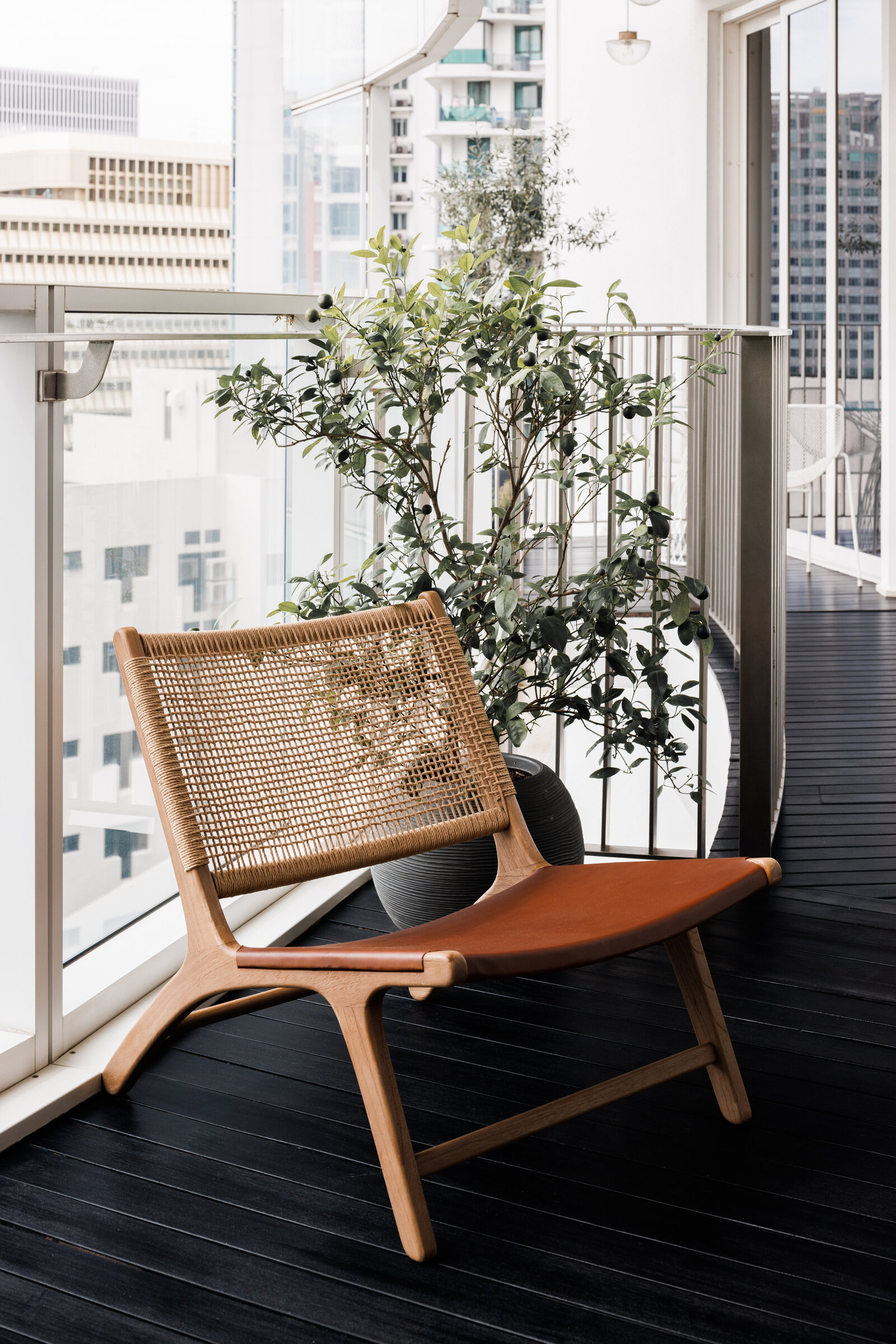 Wooden and leather lounge chair on balcony