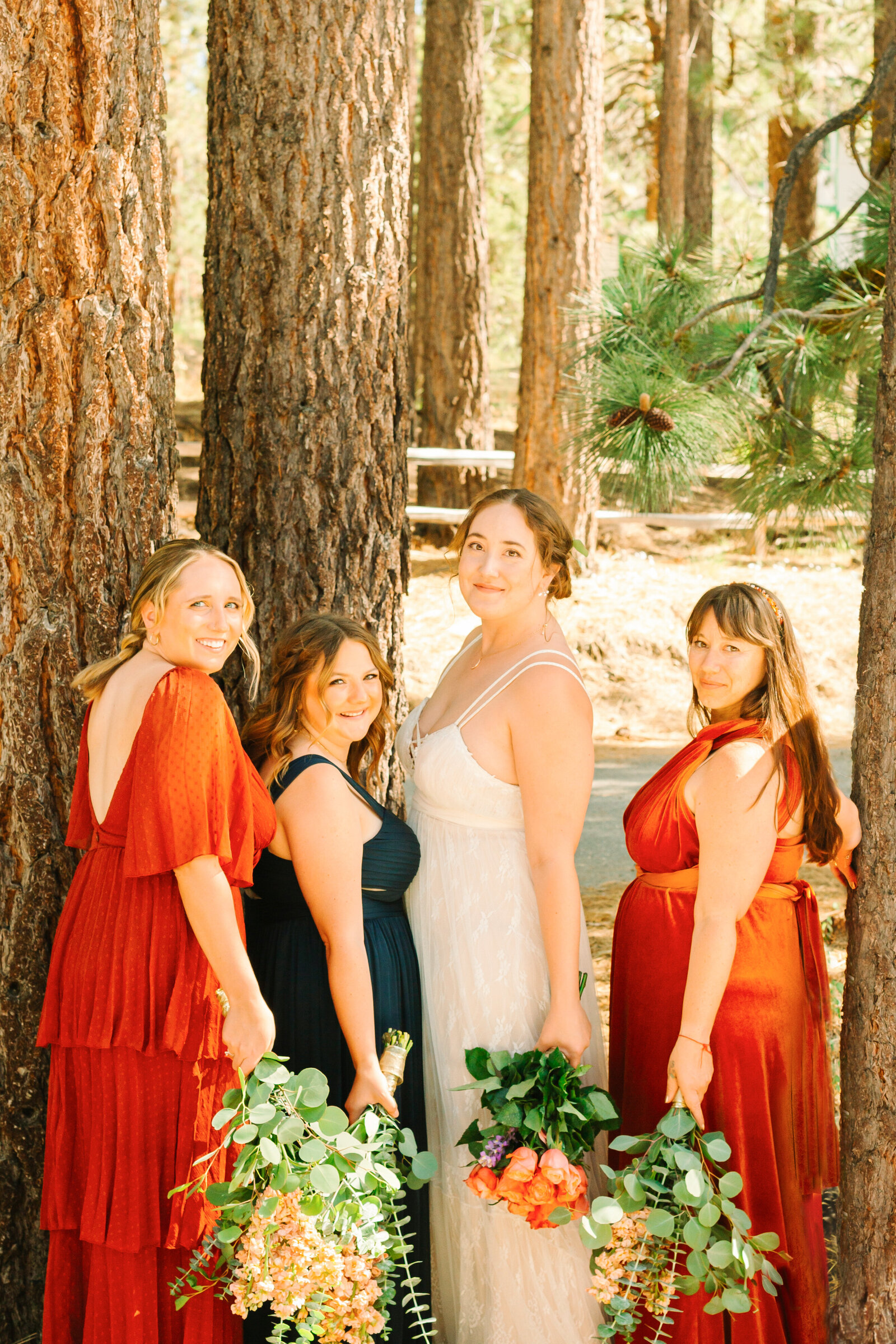 The bridal party celebrates an intimate elopement at a cabin at Big Bear Lake, California.