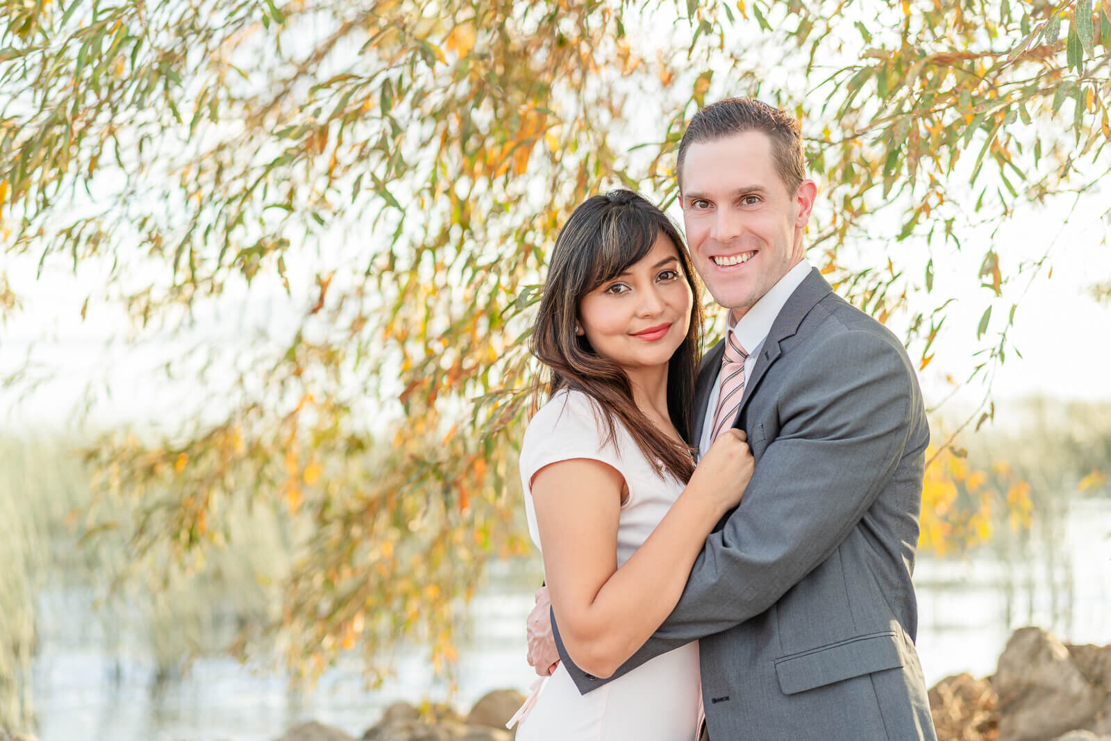 A closeup of a man holding his fiancee  at utah lake, Provo. Captured by utah engagement photographer Melissa Woodruff Photography
