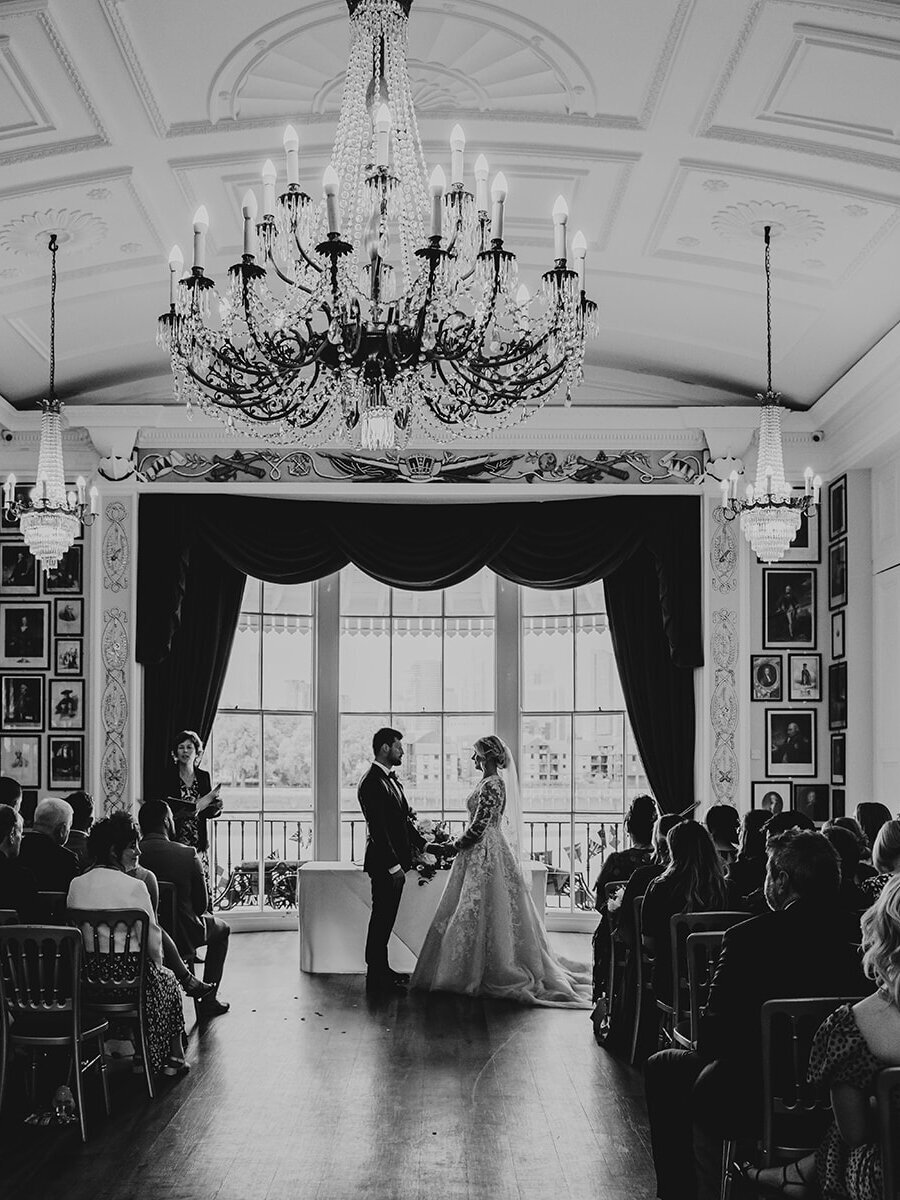 Bride and groom exchanging vows at their wedding at the Trafalgar Tavern wedding venue in London