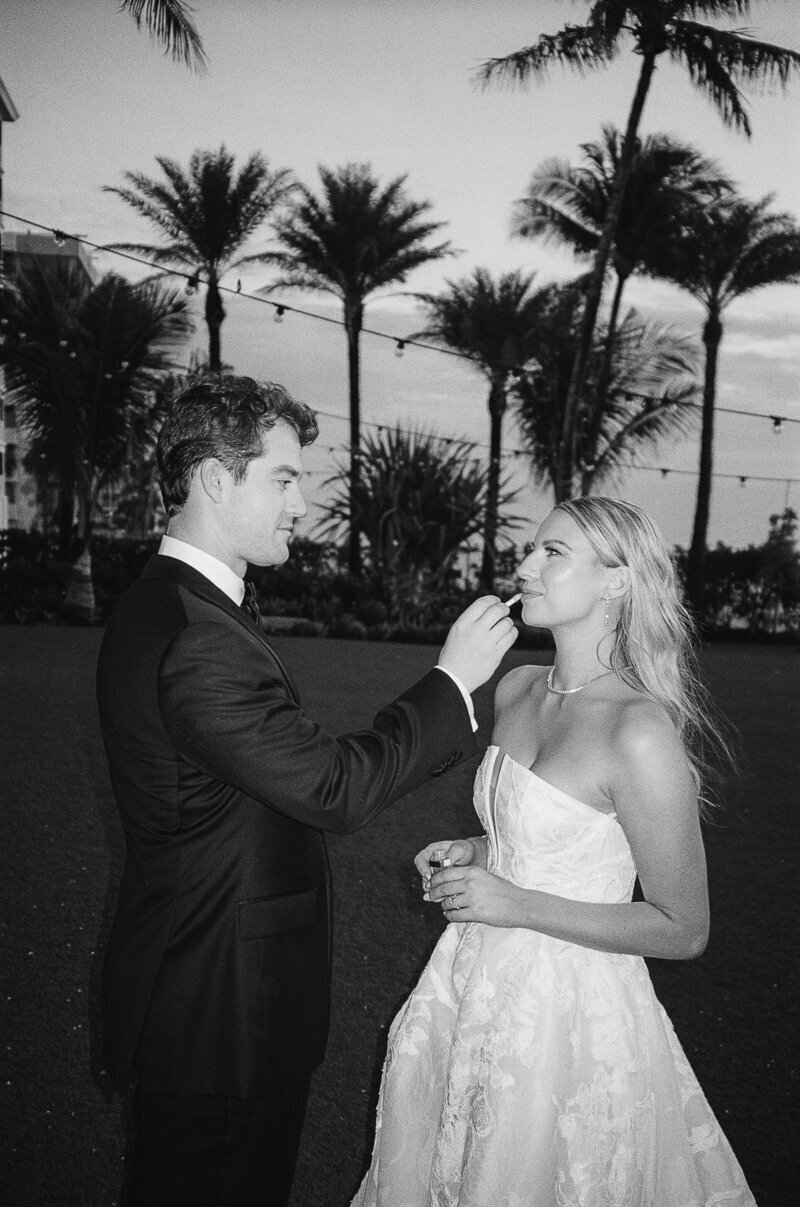 groom feeding bride in Fort Myers at their wedding