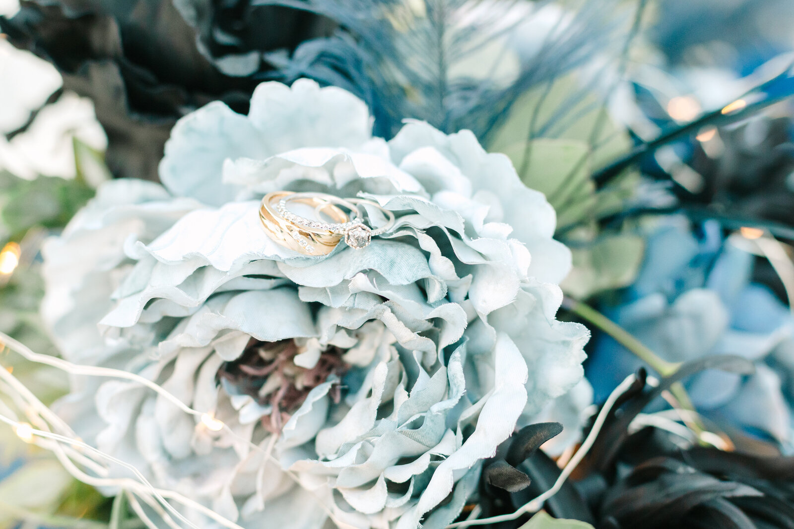 Wedding rings with blue wedding flowers.