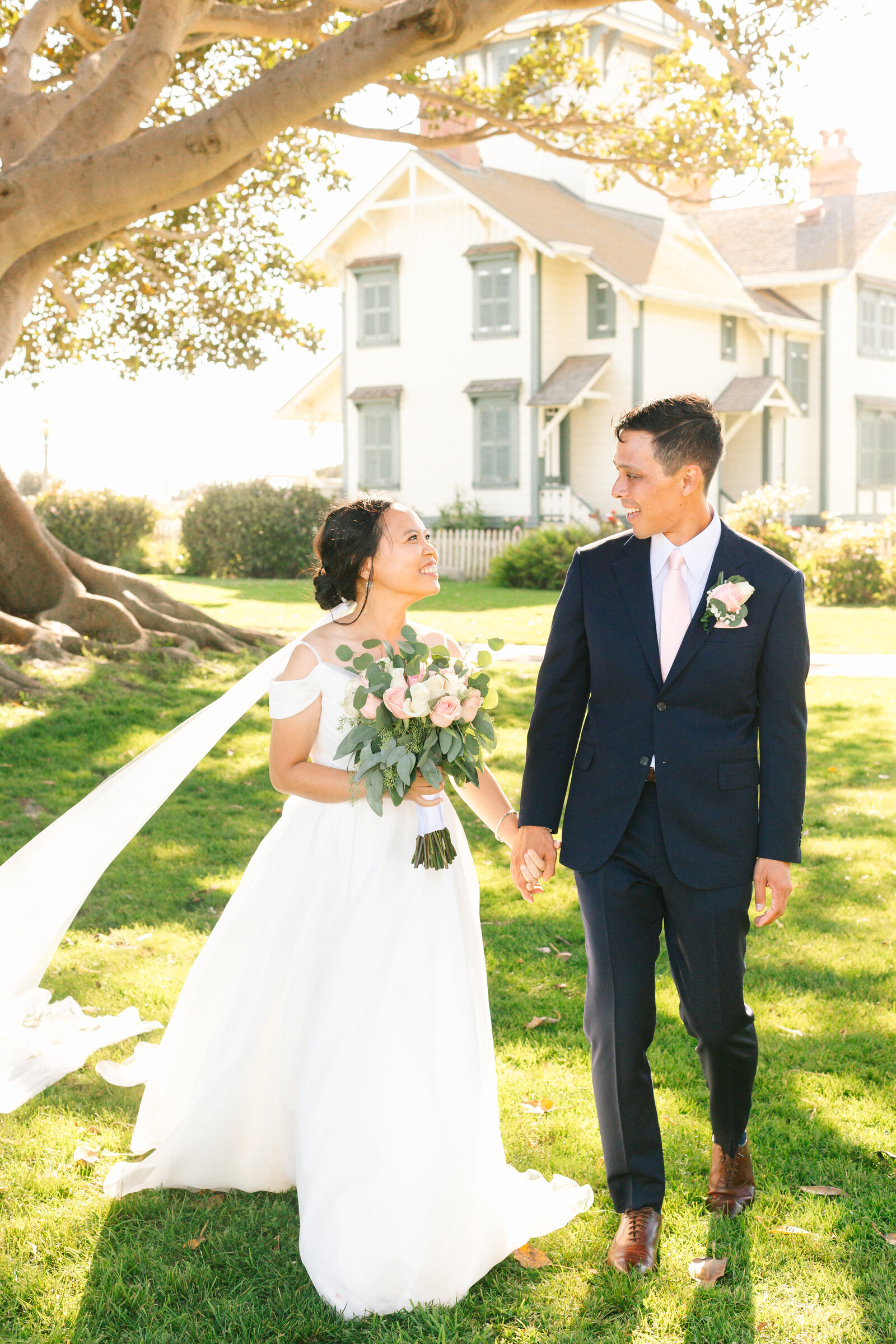 A newlywed couple holds hands after their wedding ceremony in San Pedro, Ca.