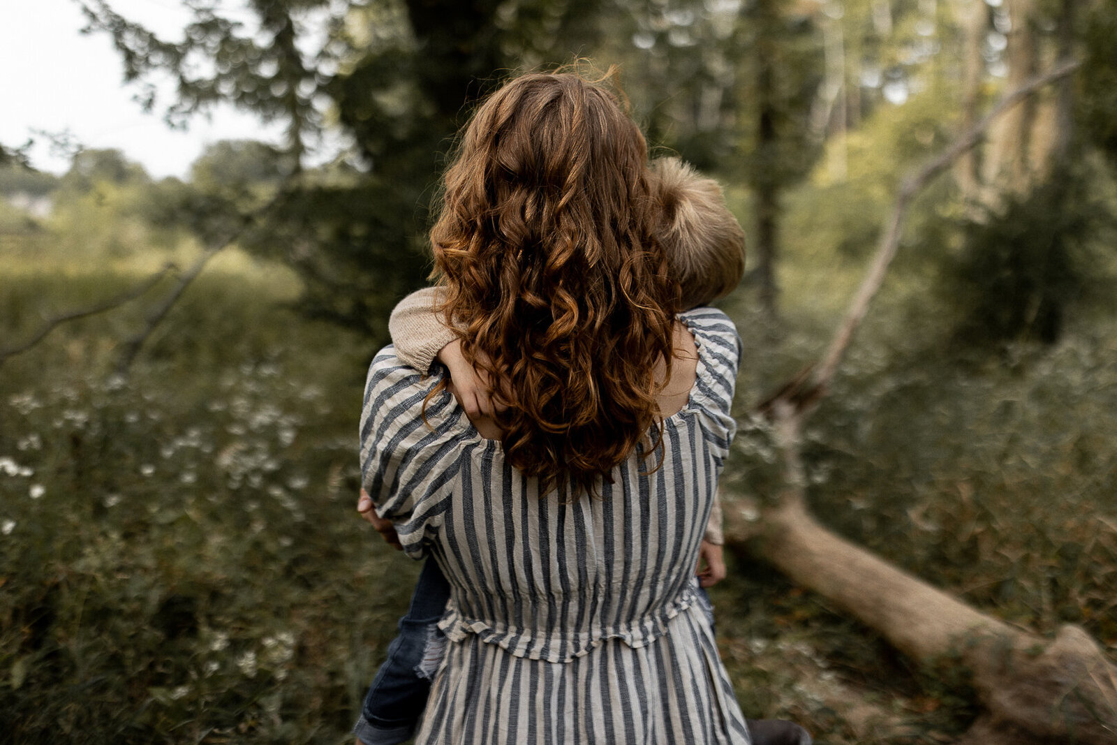 Mother walks in Jester Park holding her son