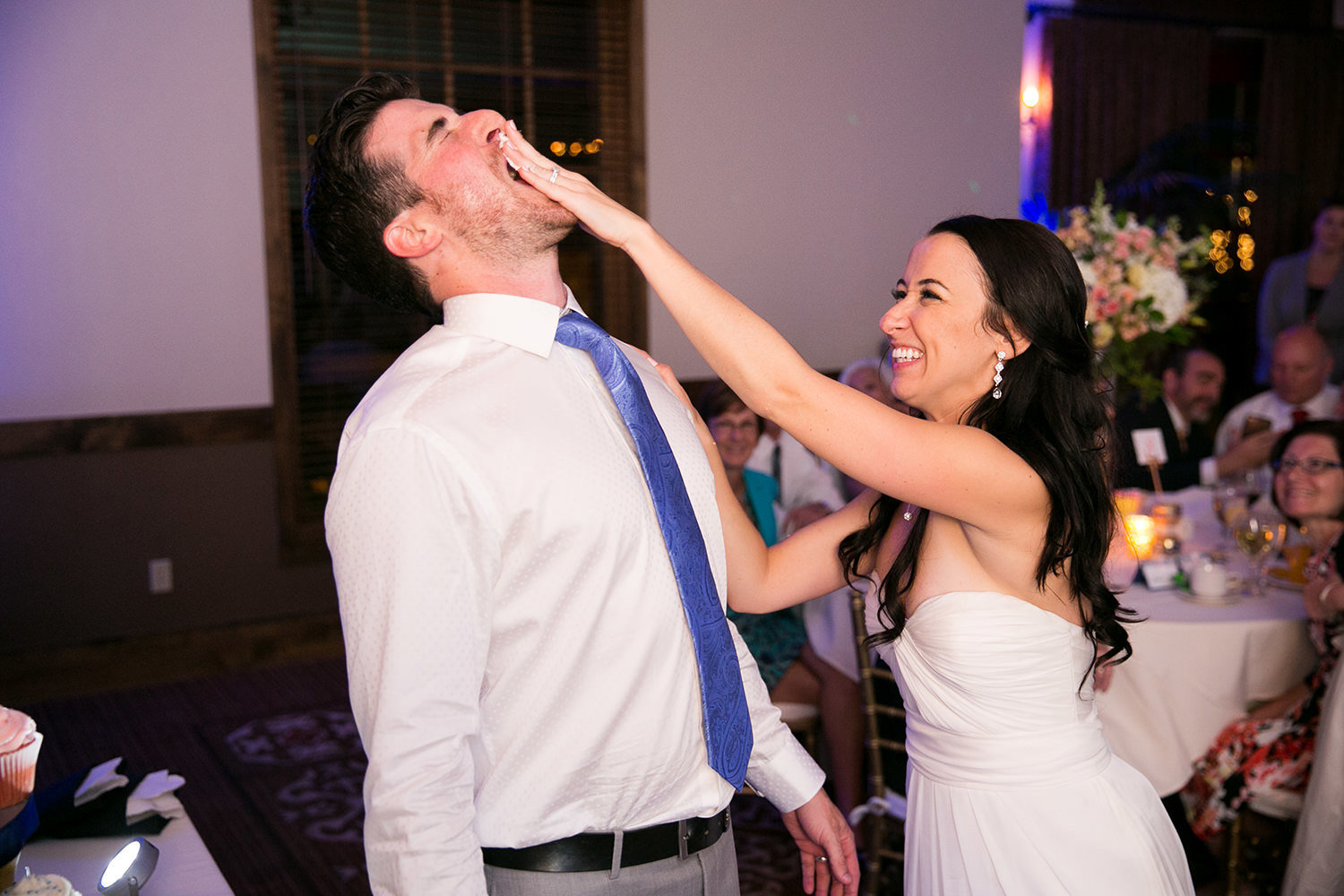 bride smashing cake in grooms face