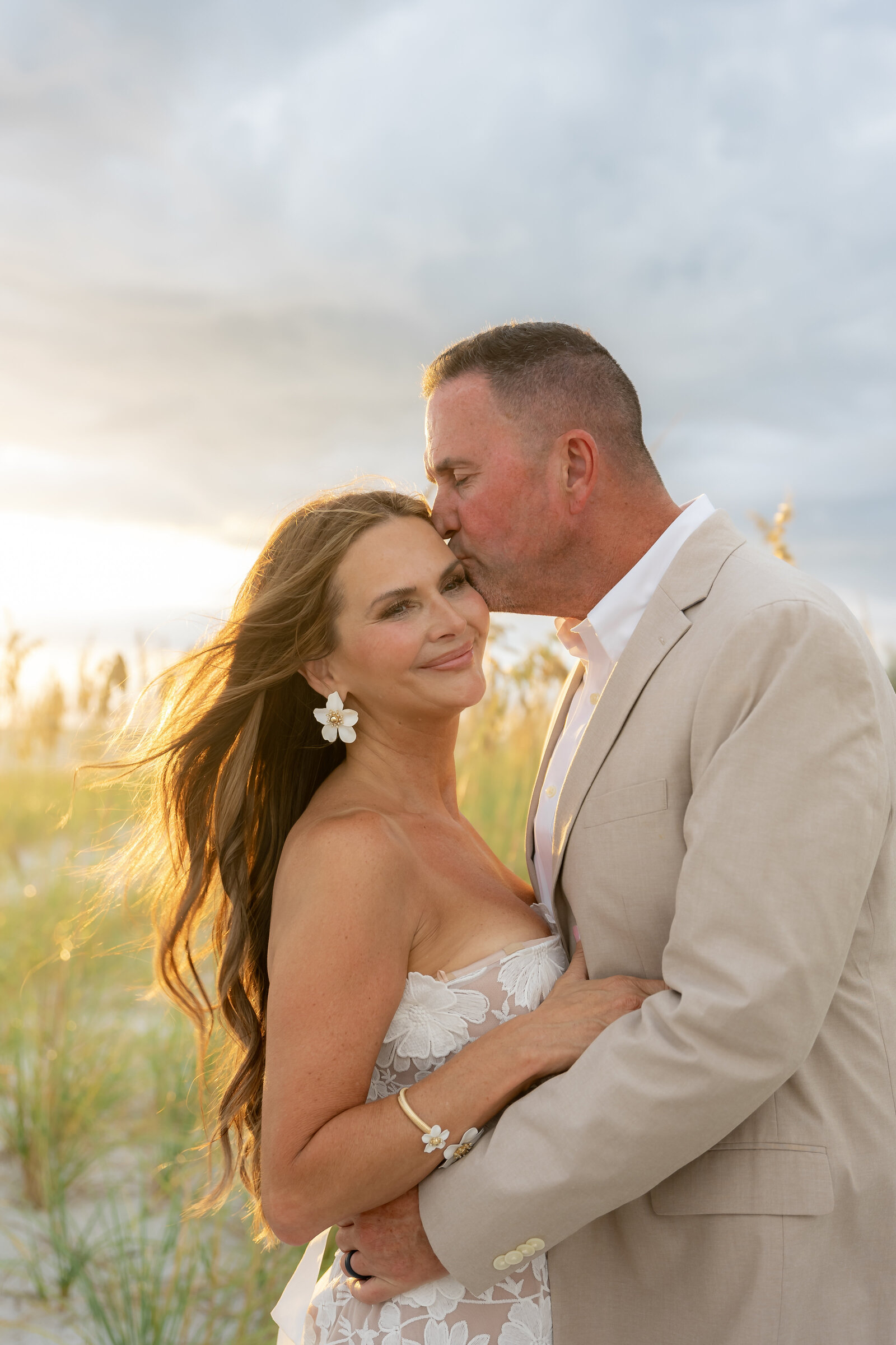 Professional wedding  portrait with bride and groom on the beach at sunset in Sarasota