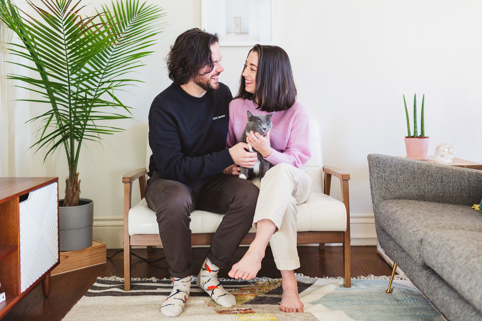couple celebrating engagement with their cat at home in san francisco