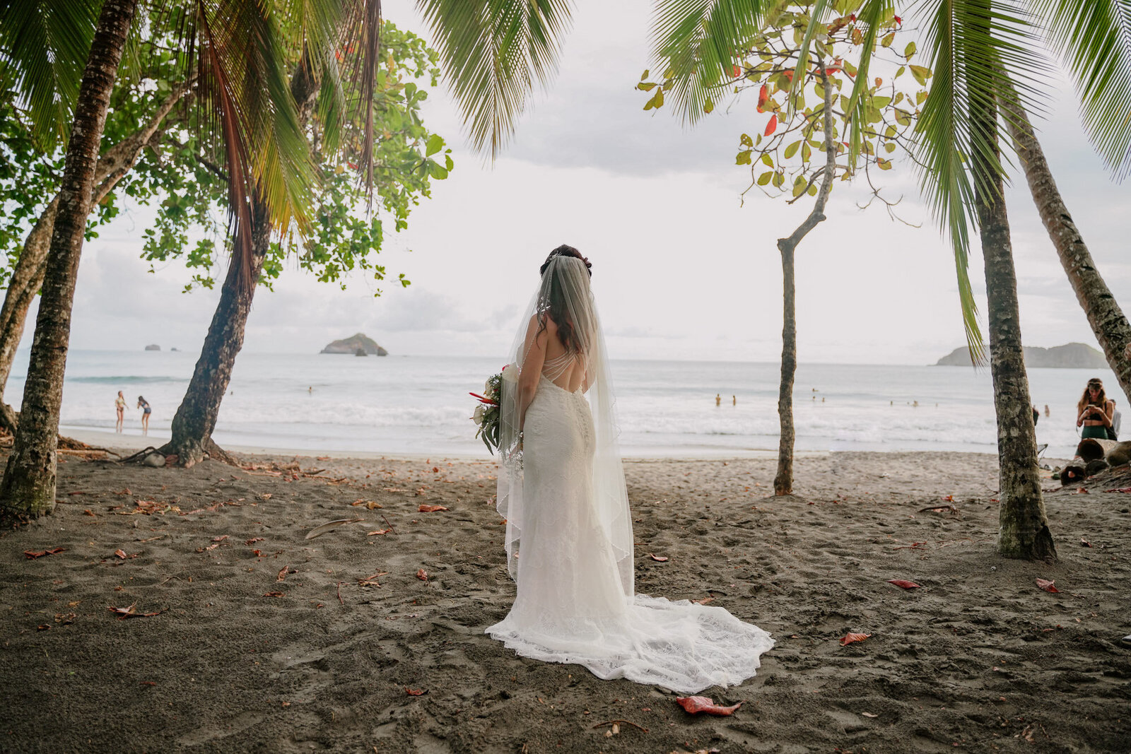 bride standing on the beach