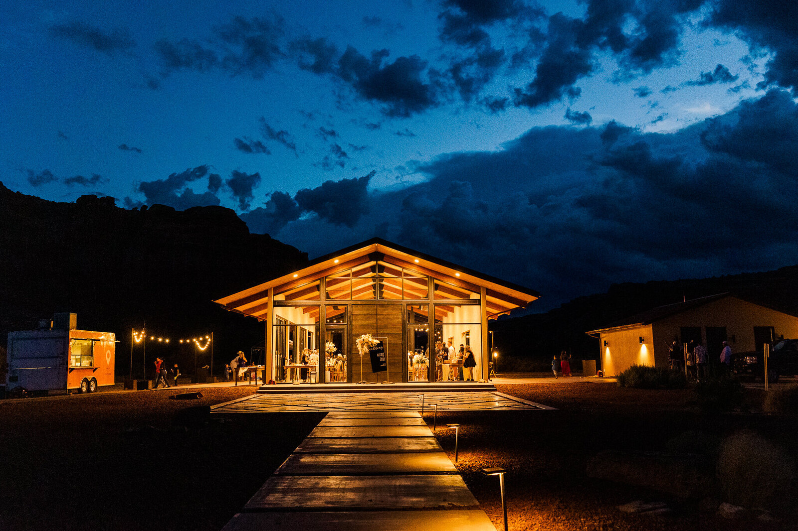 Exterior of the red earth venue after sunset with deep blue skies