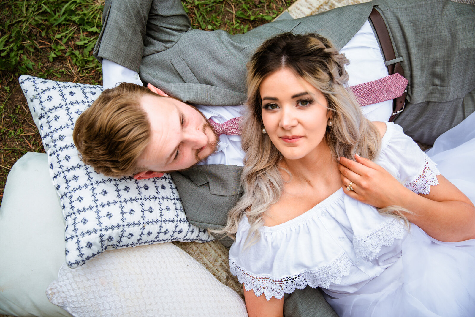 Jackson Hole photographers capture couple laying together on blanket after outdoor elopement