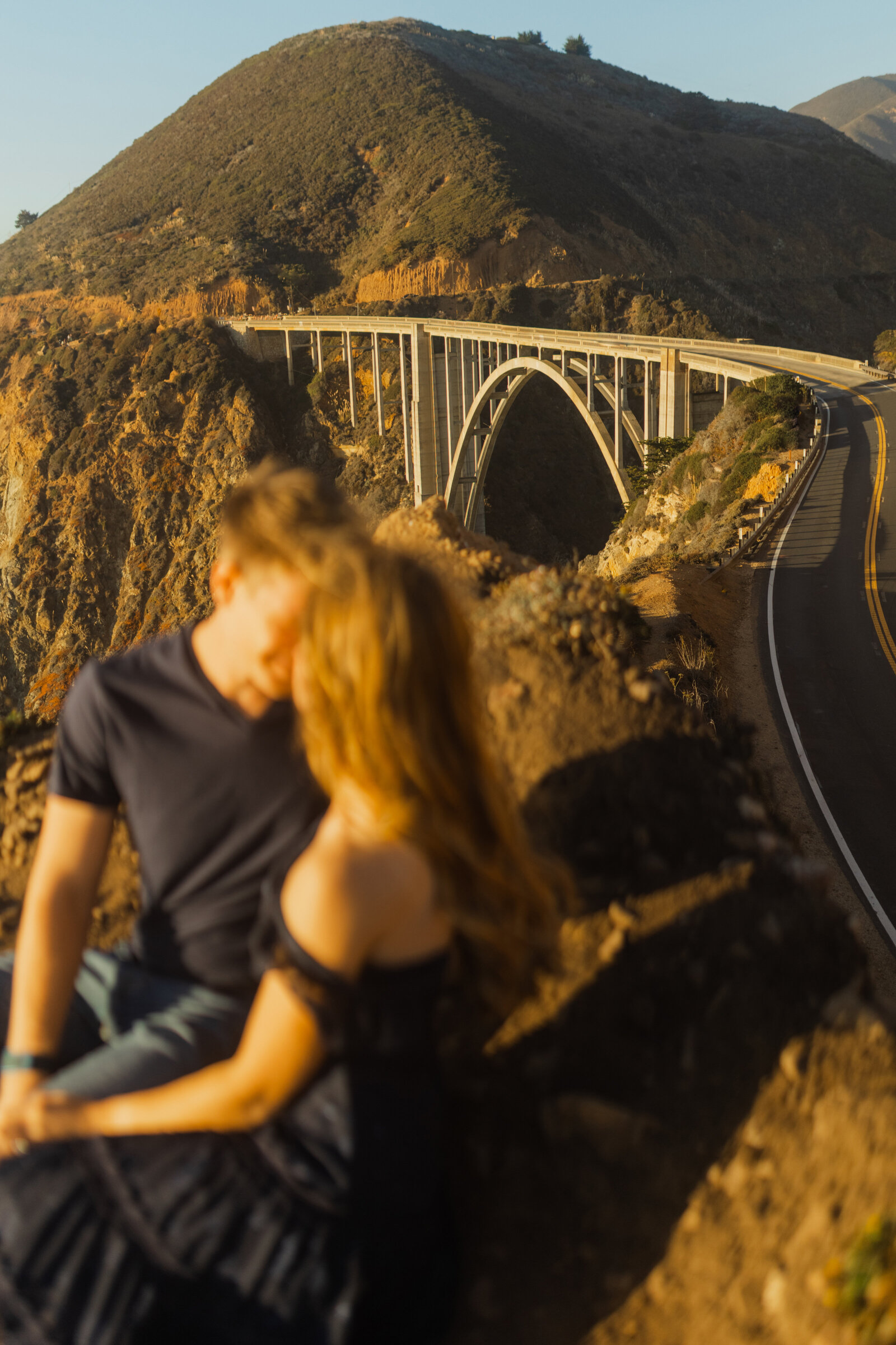 A couple poses for their engagement photos in Big Sur, California.