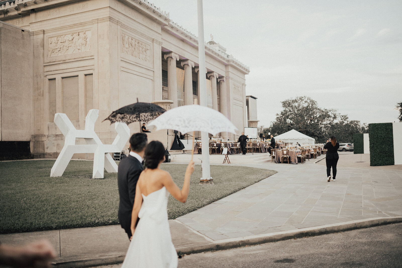 Couple walking up to building with tables setup outside