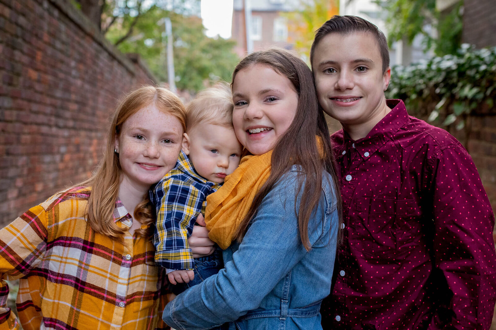Four siblings snuggling together during a family photo session in Northern Virginia.