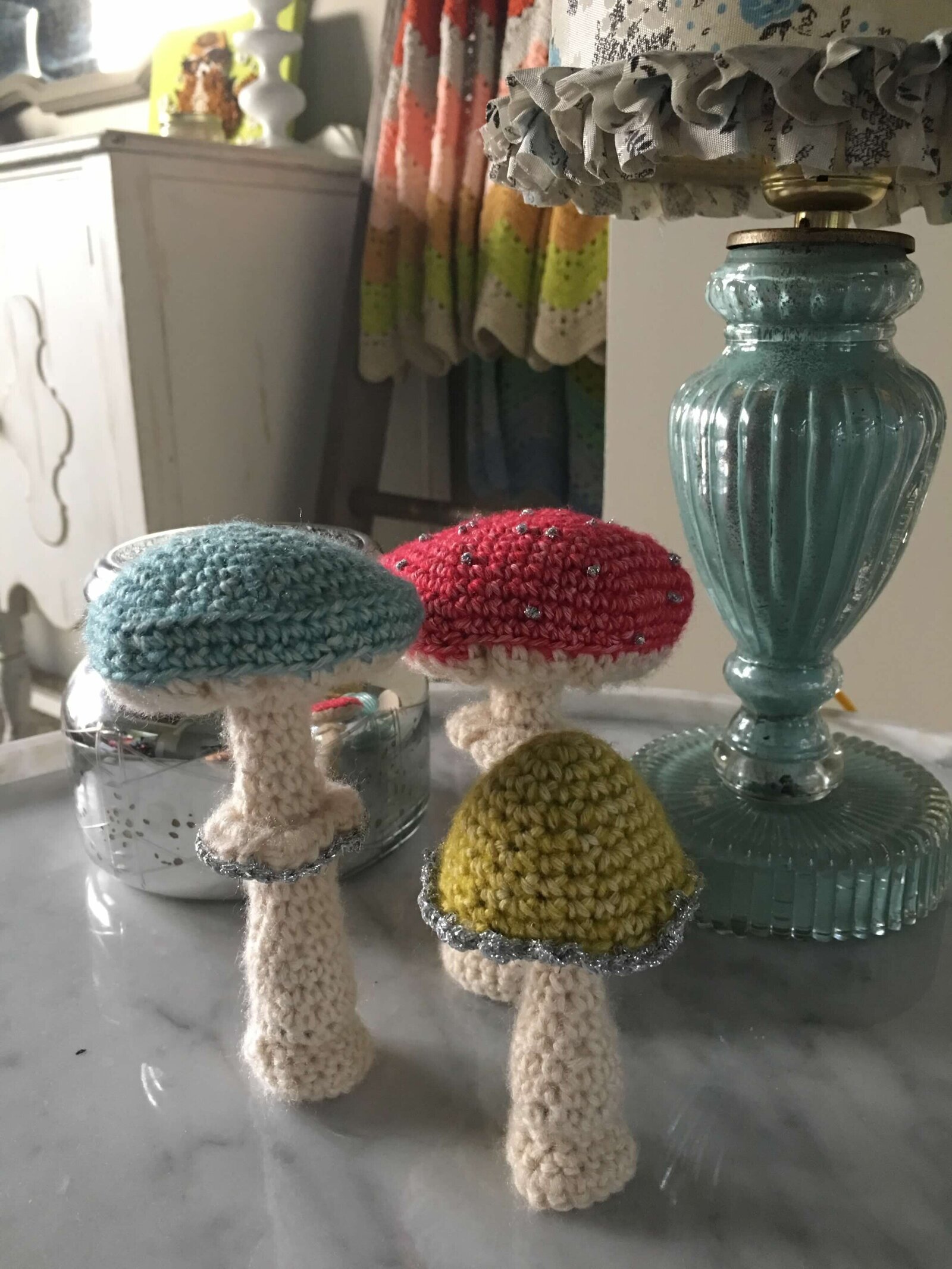 Set of three mushrooms that are hand crocheted.