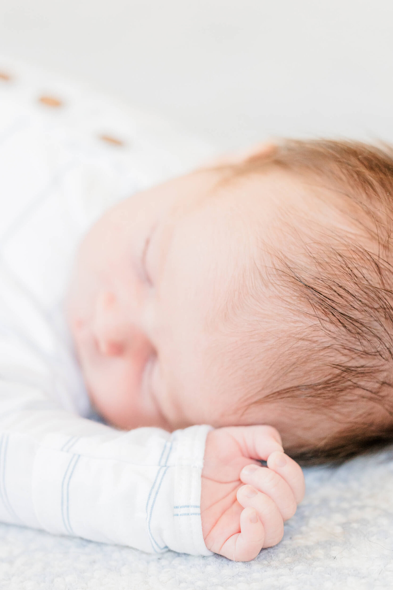 A closeup detail shot of a sleeping newborn's hand