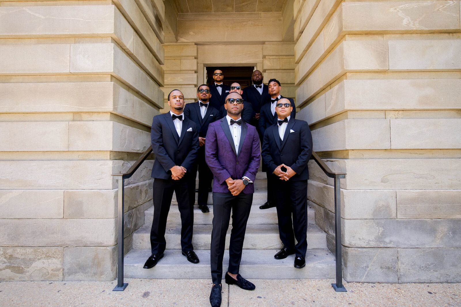 Classic groomsmen portrait at an outdoor wedding, coordinated by a luxury wedding planner.