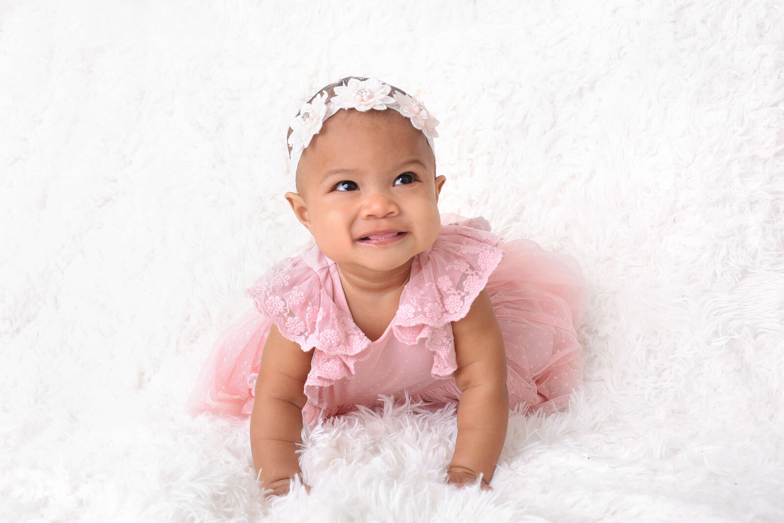 baby girl smiles at half birthday session