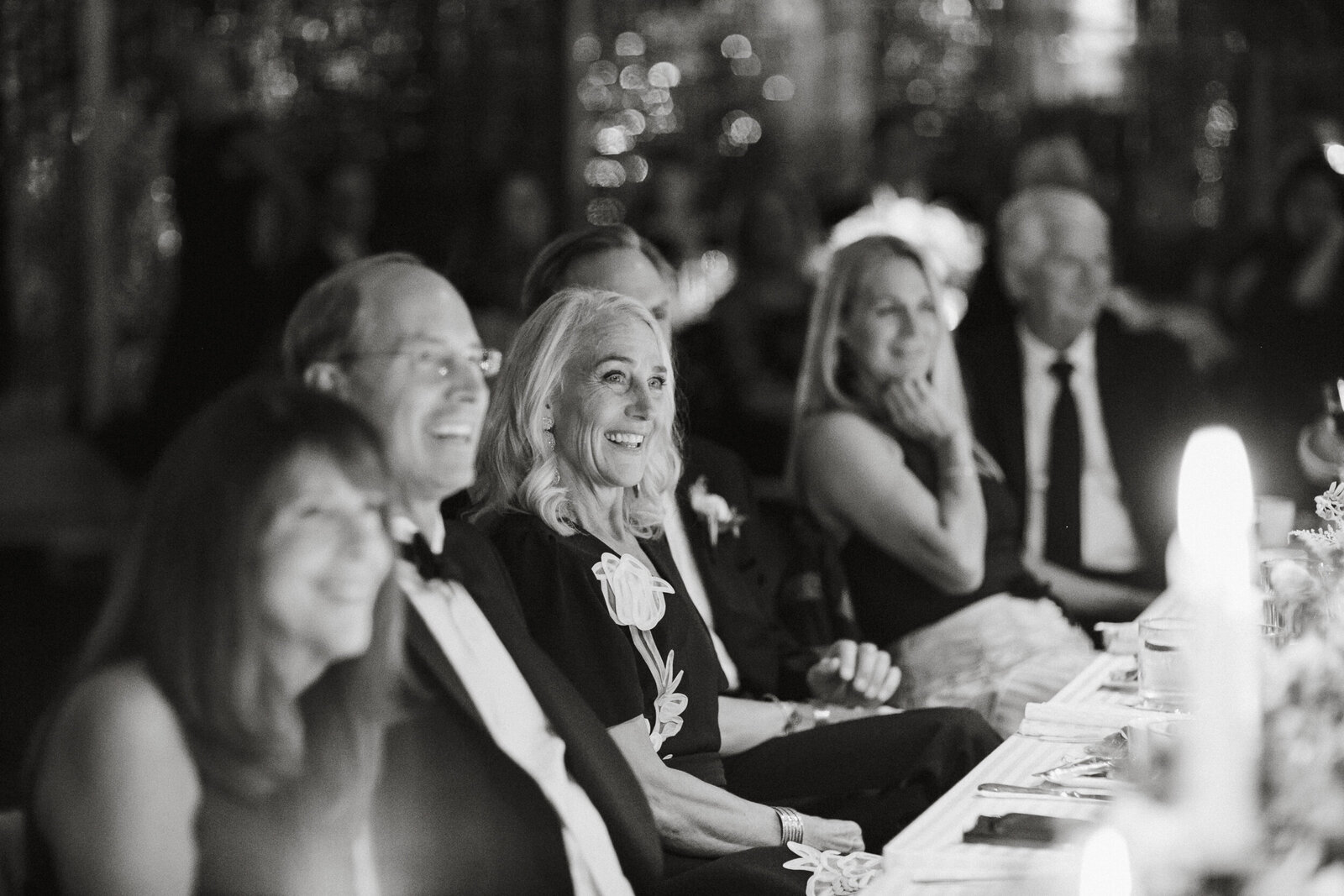 Laughing during speeches at the reception in Chester County captured by Philadelphia wedding photographers.