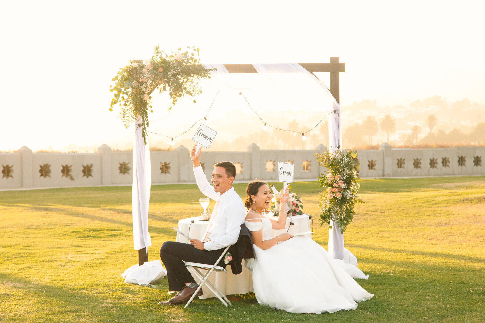 A bride and groom play a game during their wedding reception.