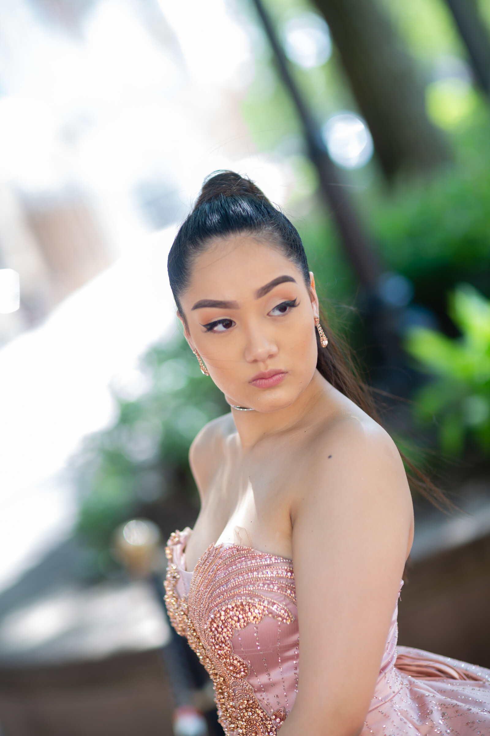 A glamorous portrait of Rosalyn Kinsey in her quinceañera gown, captured against the iconic backdrop of Playhouse Square in Cleveland, Ohio.