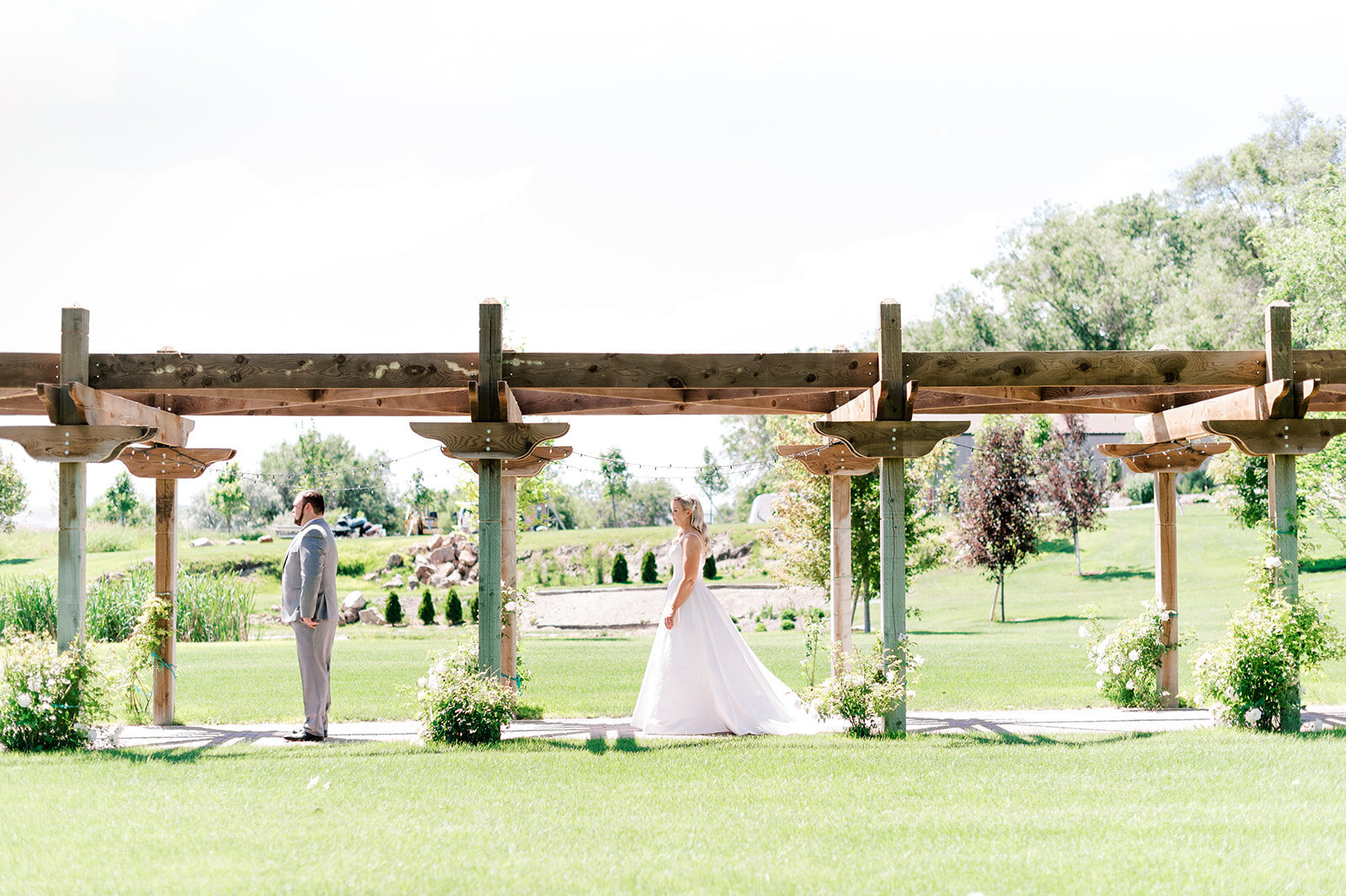 First look with bride and groom under pergola taken by the Best Boise Wedding Photographers