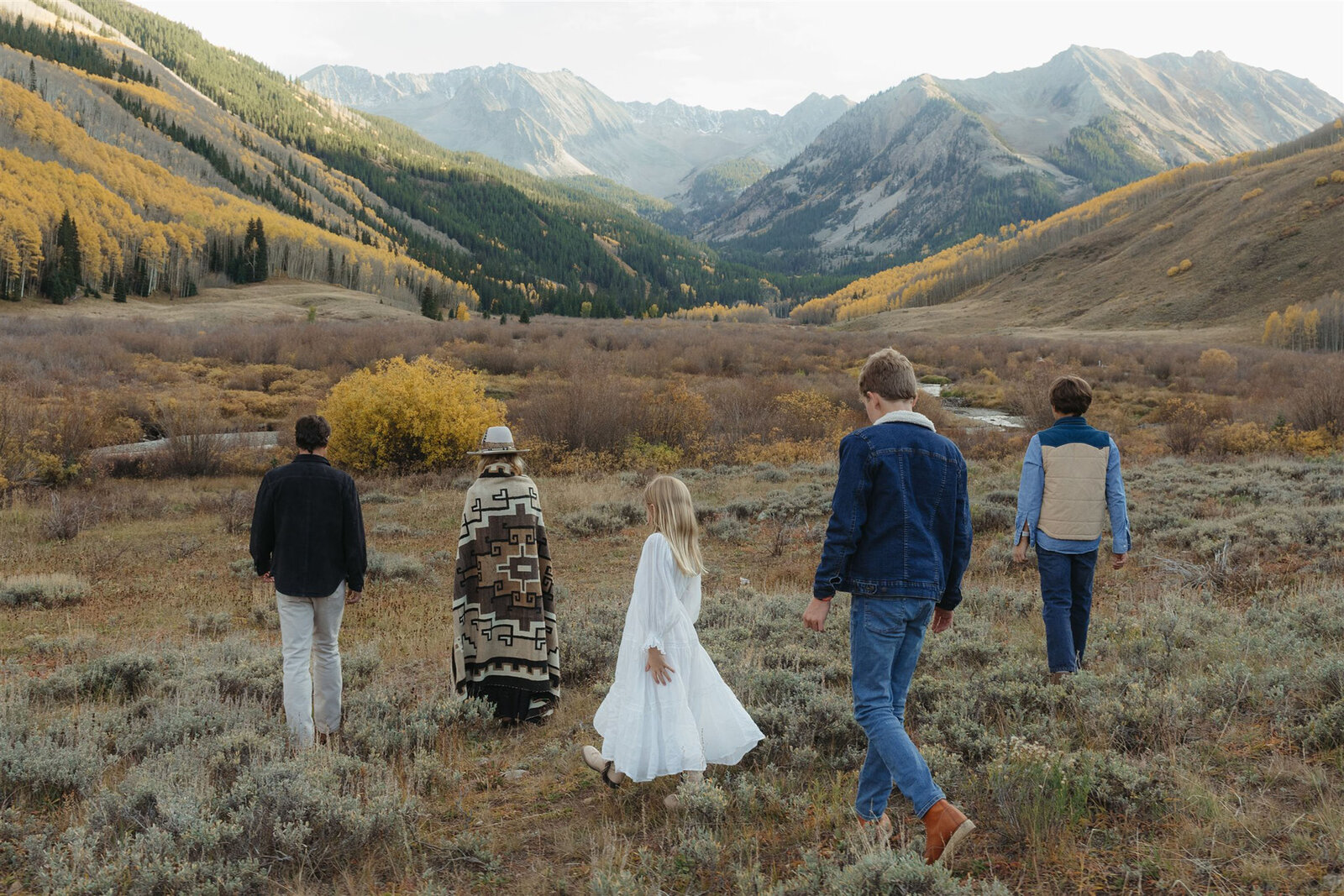 Editorial Aspen family photography — stylish family walking together in classic Ralph Lauren–inspired outfits.