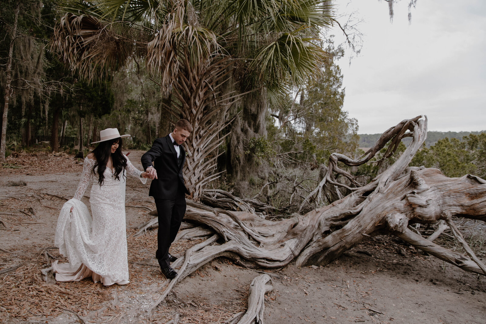 a bride and groom by driftwood in savannah georgia