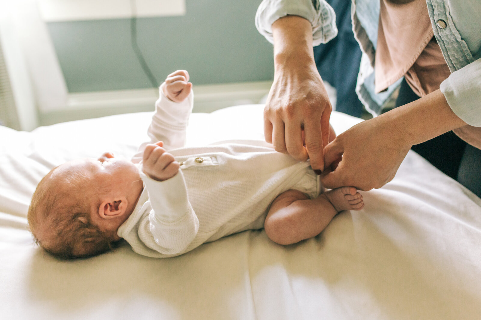 lifestyle professional photo of baby getting changed