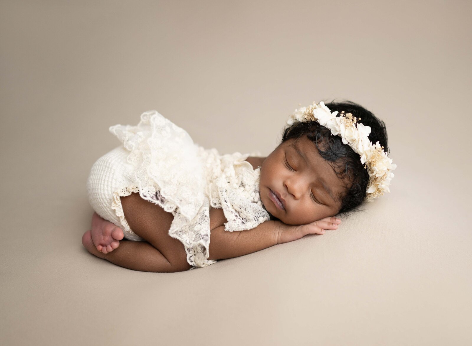 Baby girl in cream lace outfit, sleeping on tummy with bum in air. Photographed by Jenni Nikki Photography at Marietta Newborn Photo Studio.
