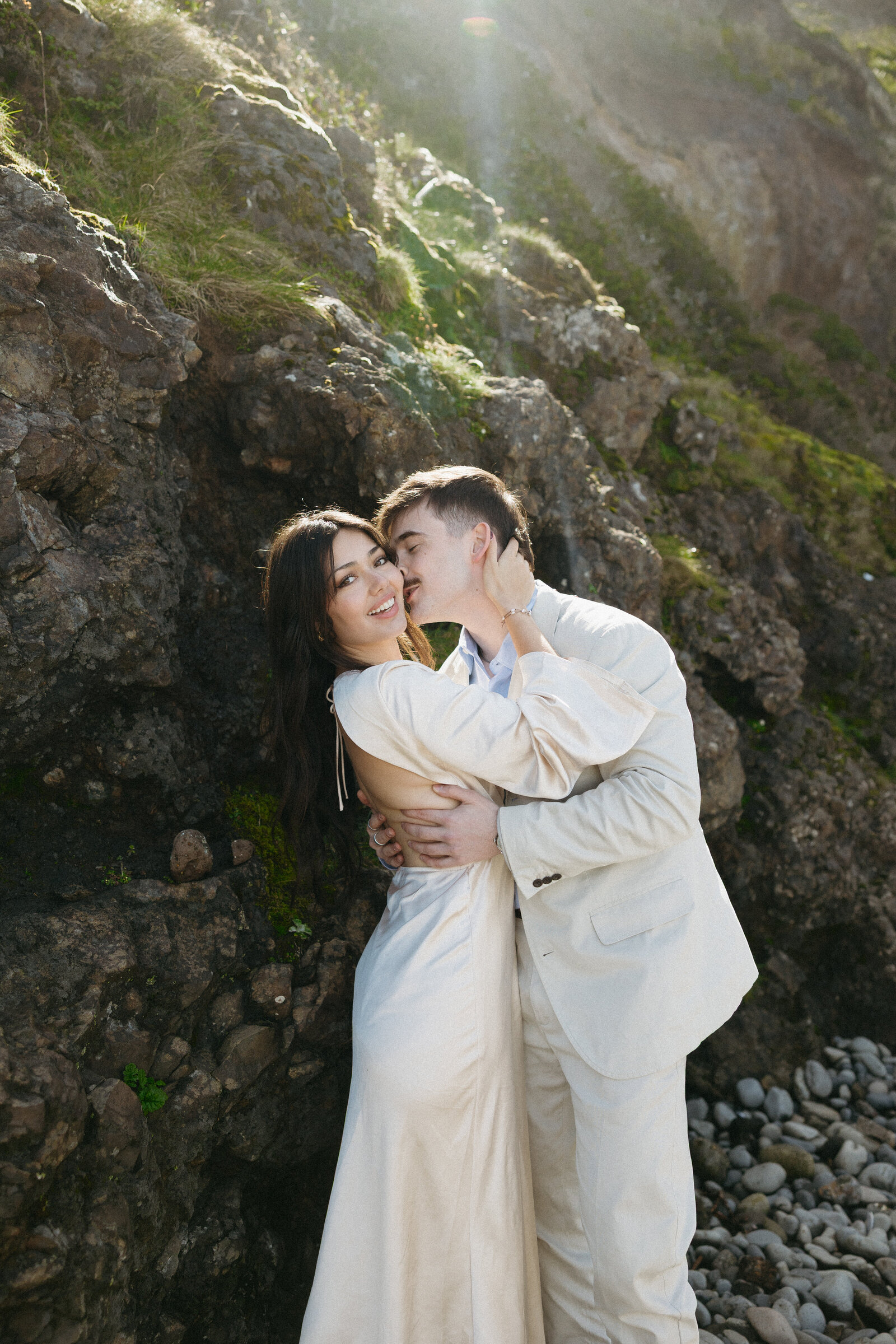 A couple poses for their bridal portraits at a beautiful beach in Tofino. 