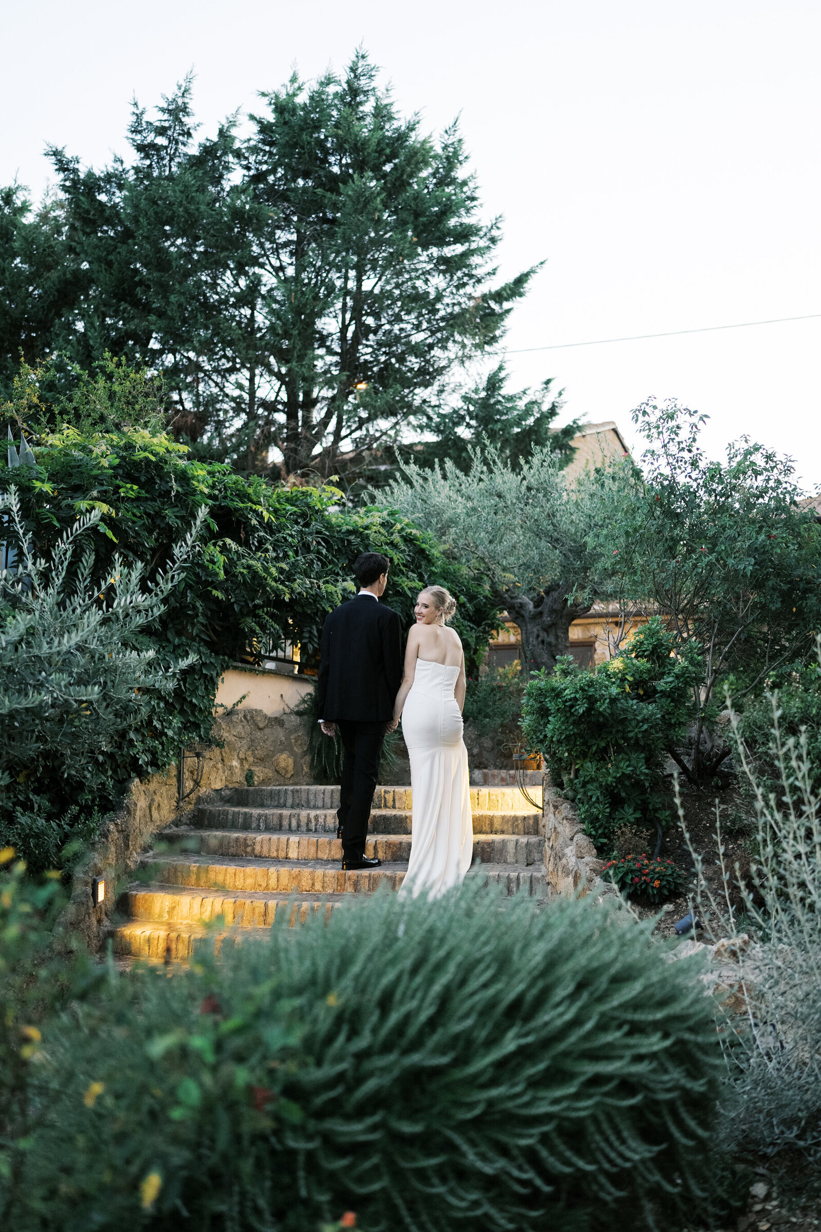 Bride and groom walking up the staircase | Megan Smith Photography
