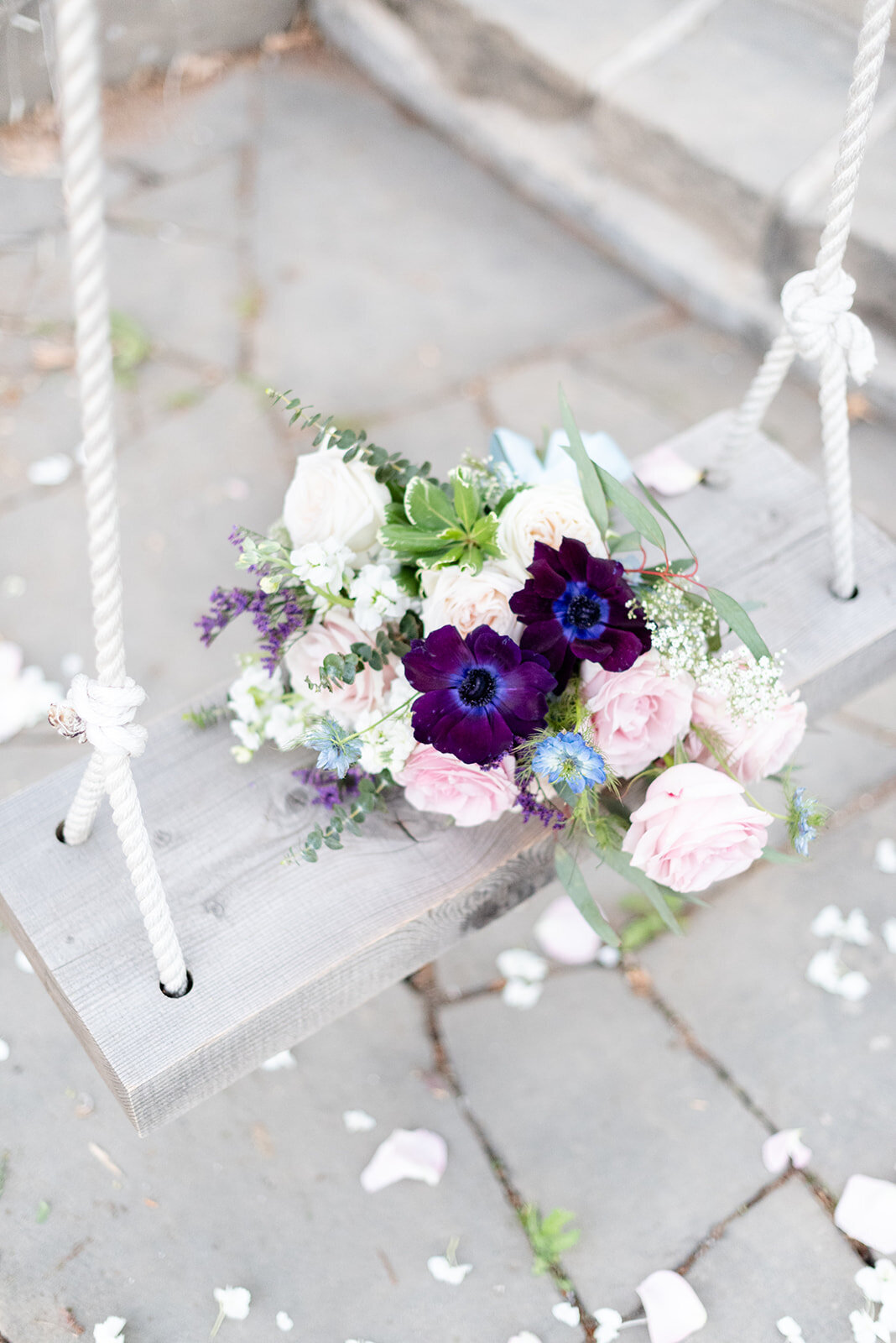 Bouquet on swing at Cottage at Riverbend Wedding by the Best Boise Wedding Photographers