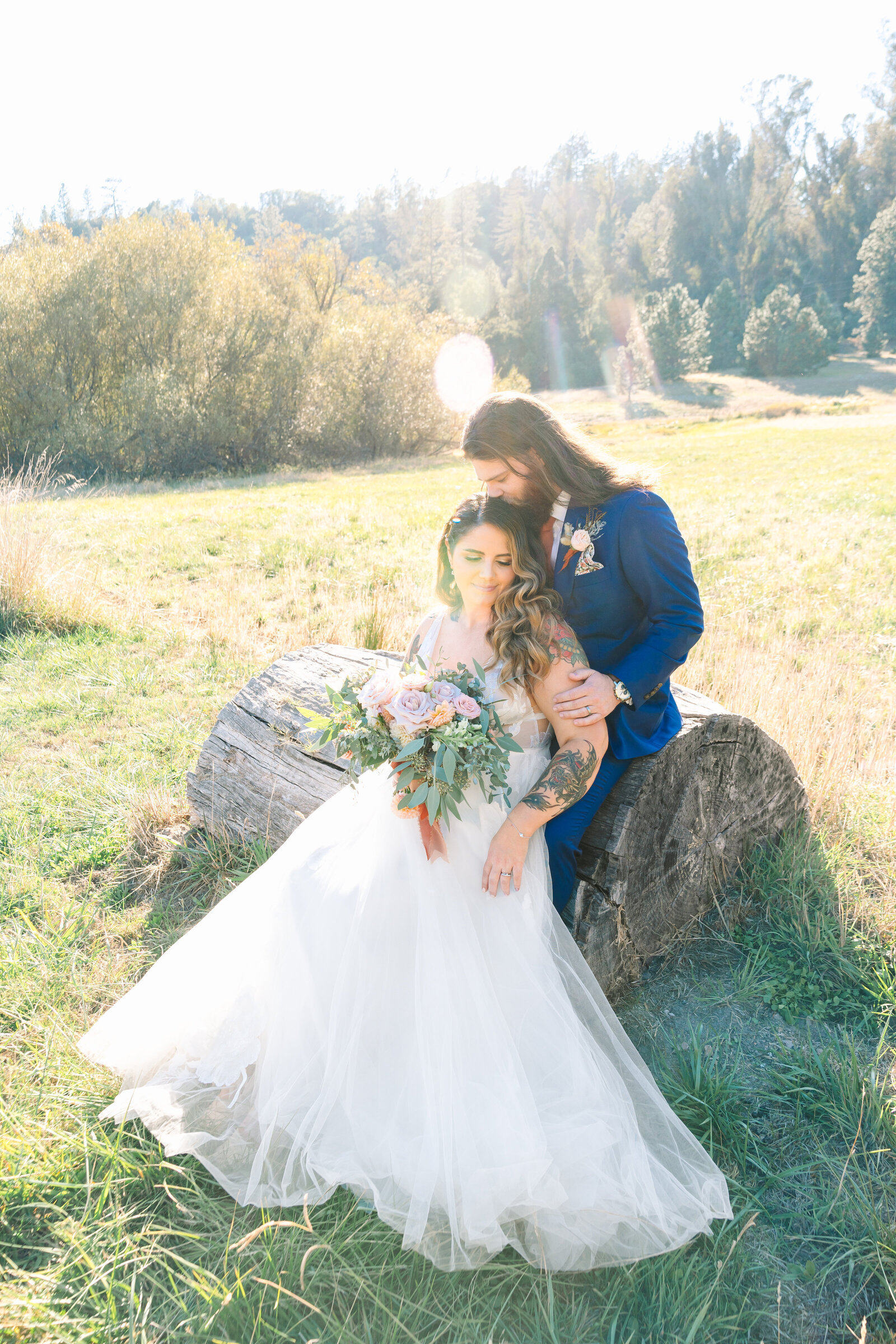 Tattoo bride and groom embrace on their colorful wedding day in Santa Cruz, California.