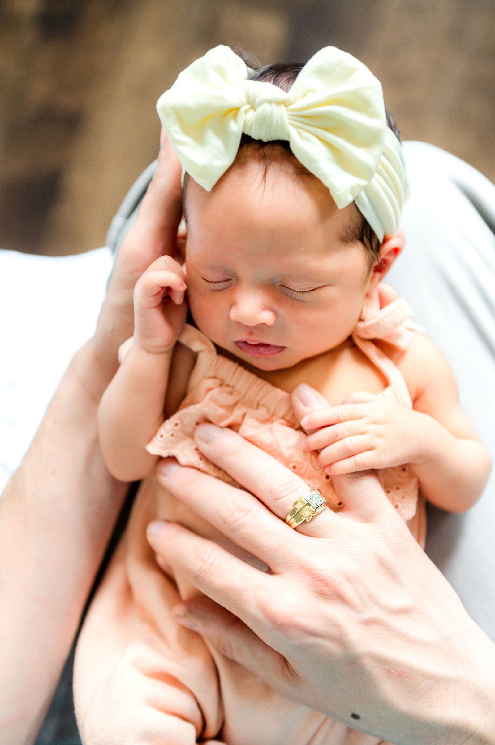 newborn baby girl holding her dads hand