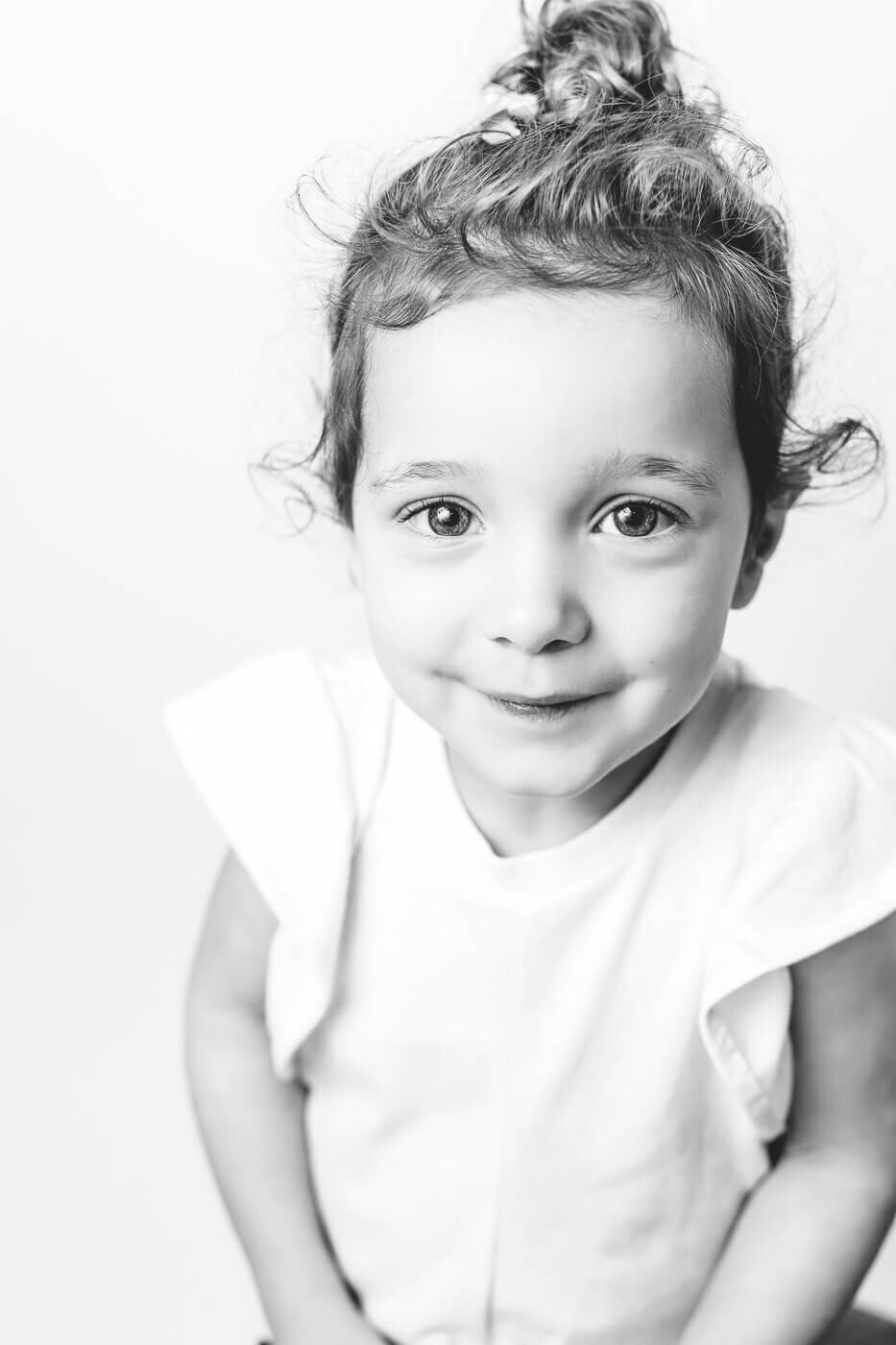 Upward angle on young girl with light and happy expression
