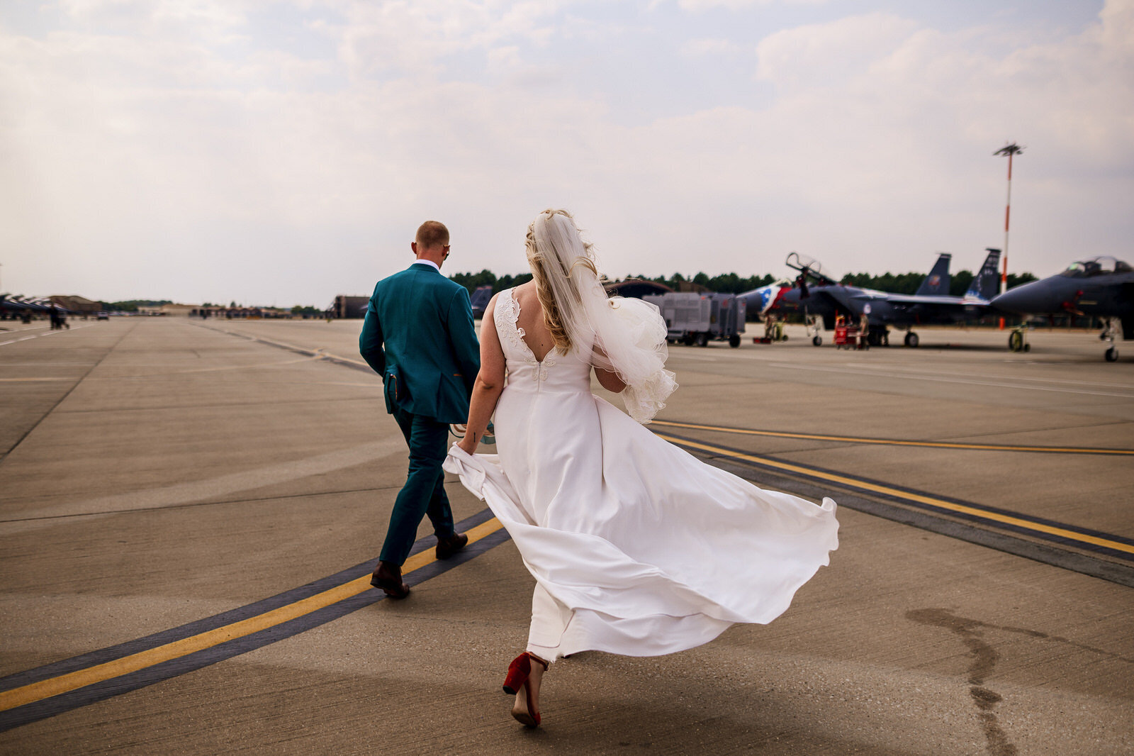 Bride and Groom having walking towards a fighter Jet f16