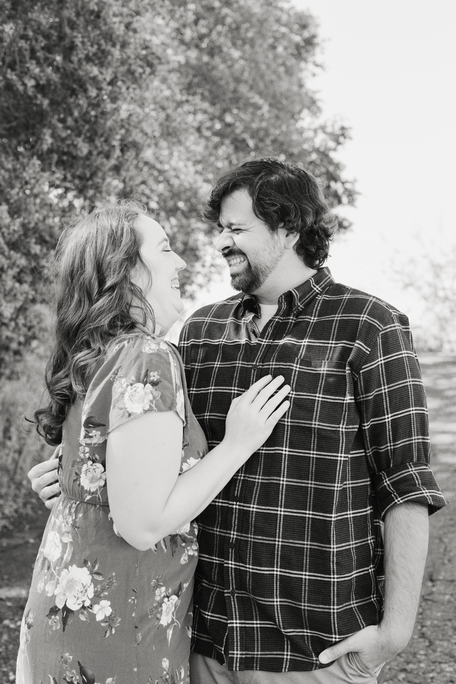 An engaged couple poses for photos in a garden in Los Angeles, Ca.
