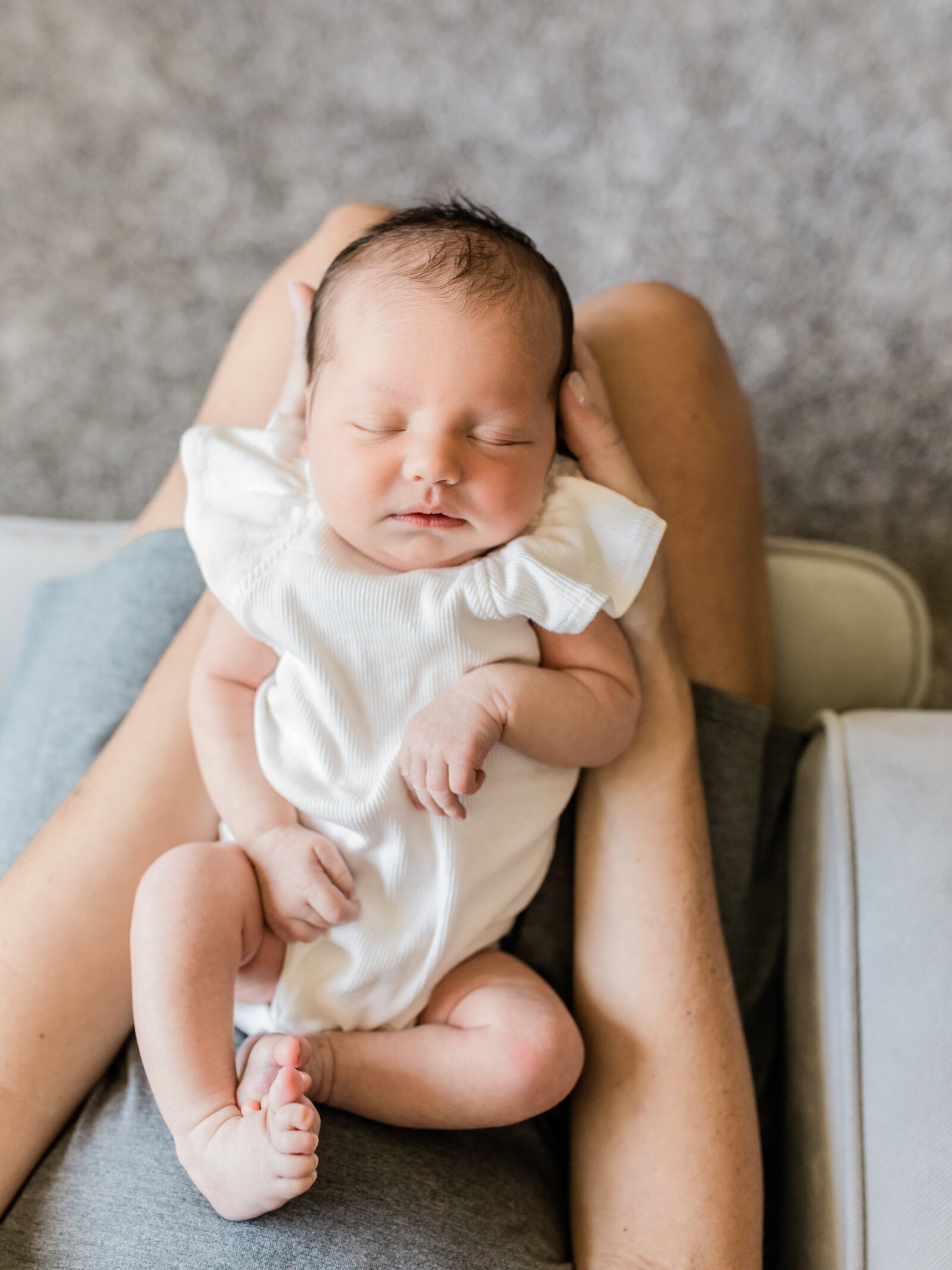 Newborn baby girl in mom's lap