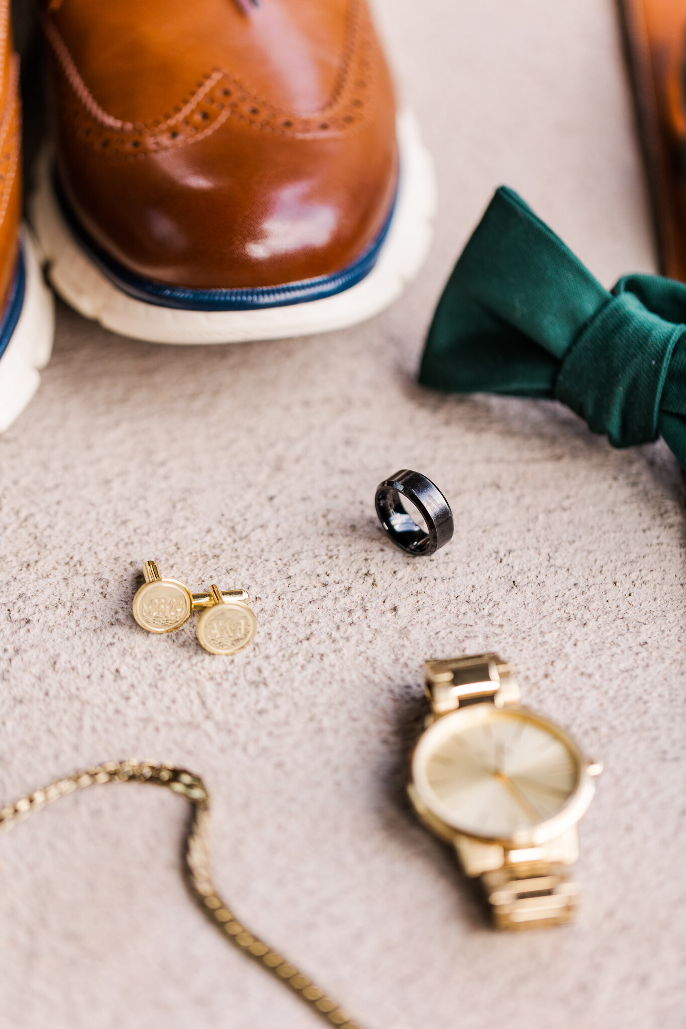 Groom details- green bow tie, gold watch, gold cuff clinks at a Utah Wedding