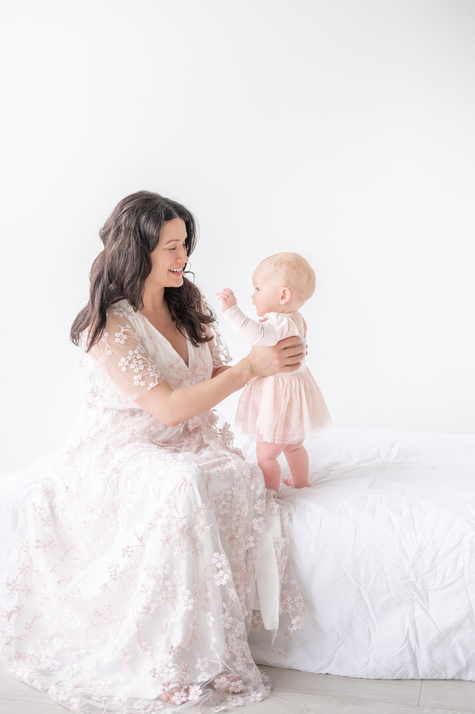 Mom and baby playing taken by Apex Newborn Photographer