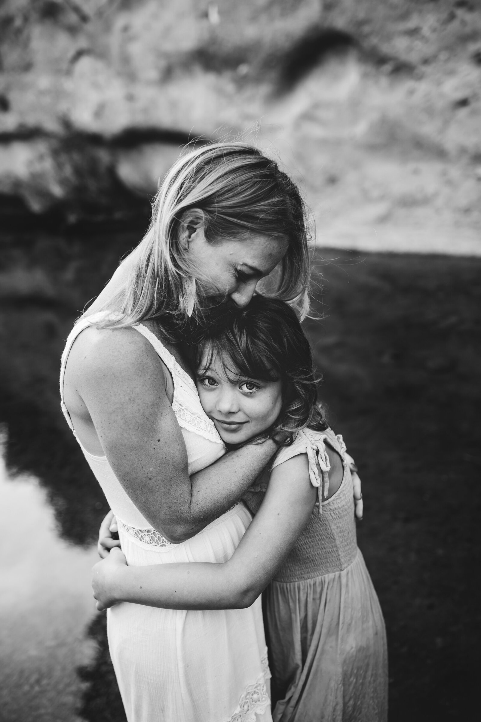 untitled-201009-178-Edit-2Mother-embraces-daughter-girl-looks-into-camera-bnw-emotive-ventura-county