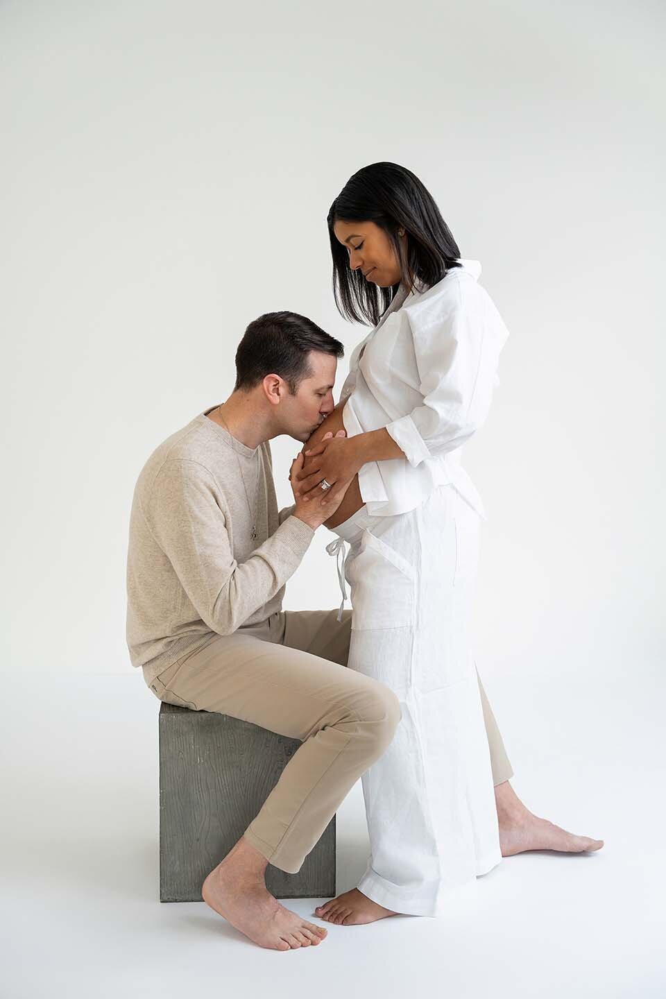 man-kissing-belly-of-pregnant-wife