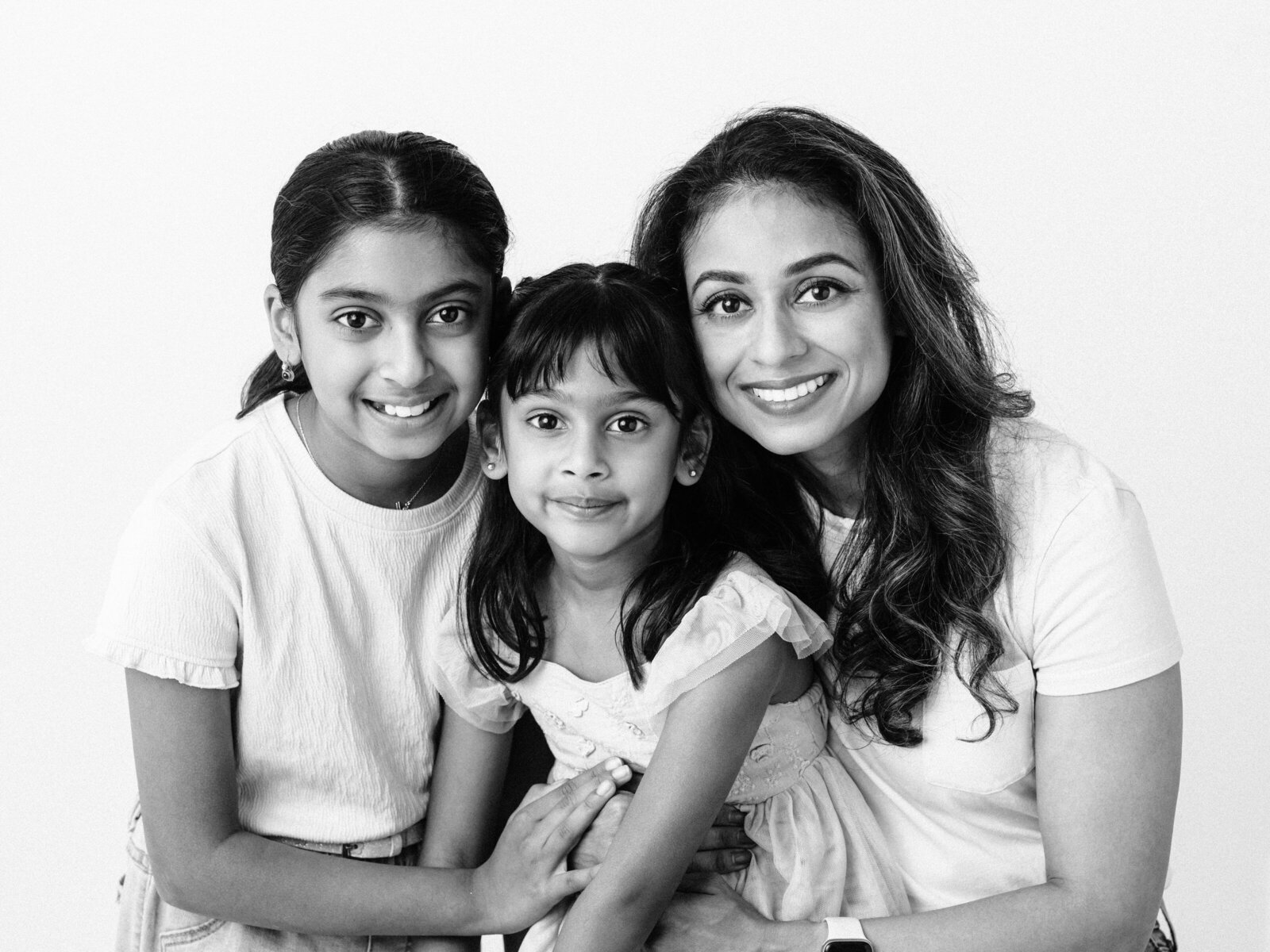 Mother and two daughters posed for studio portraits 
