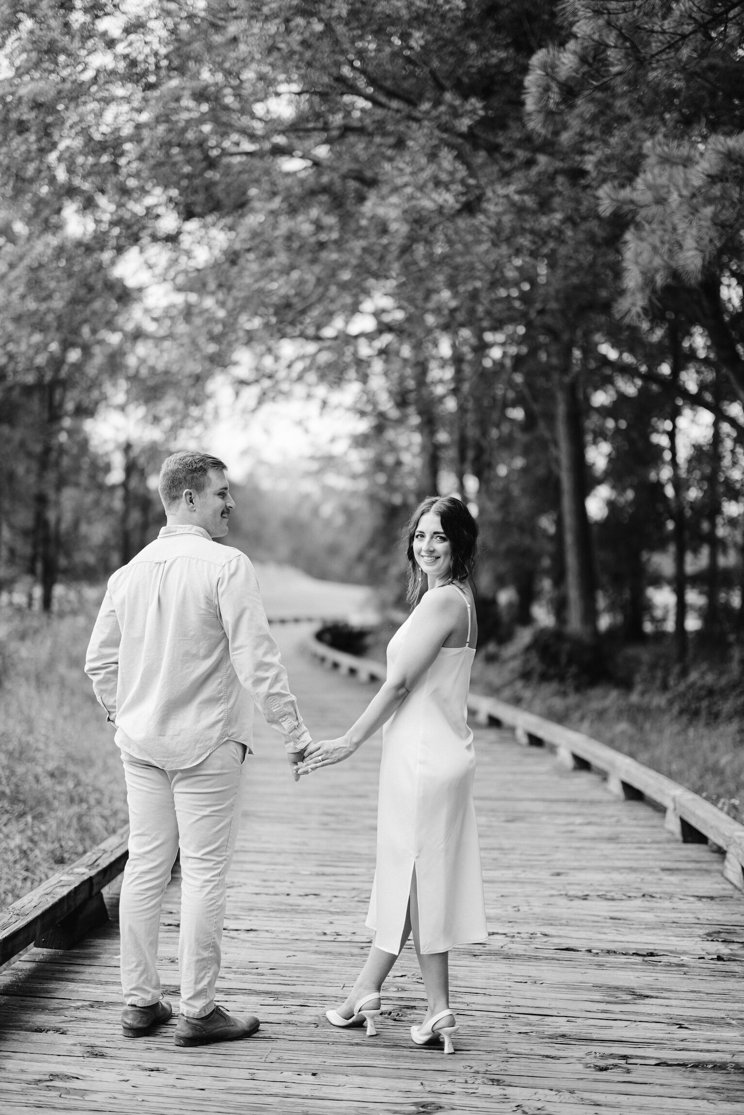 Couple enjoying a romantic engagement session at Koasati Pines Golf Course, captured on film by Morgan Alysse, Louisiana film photographer.