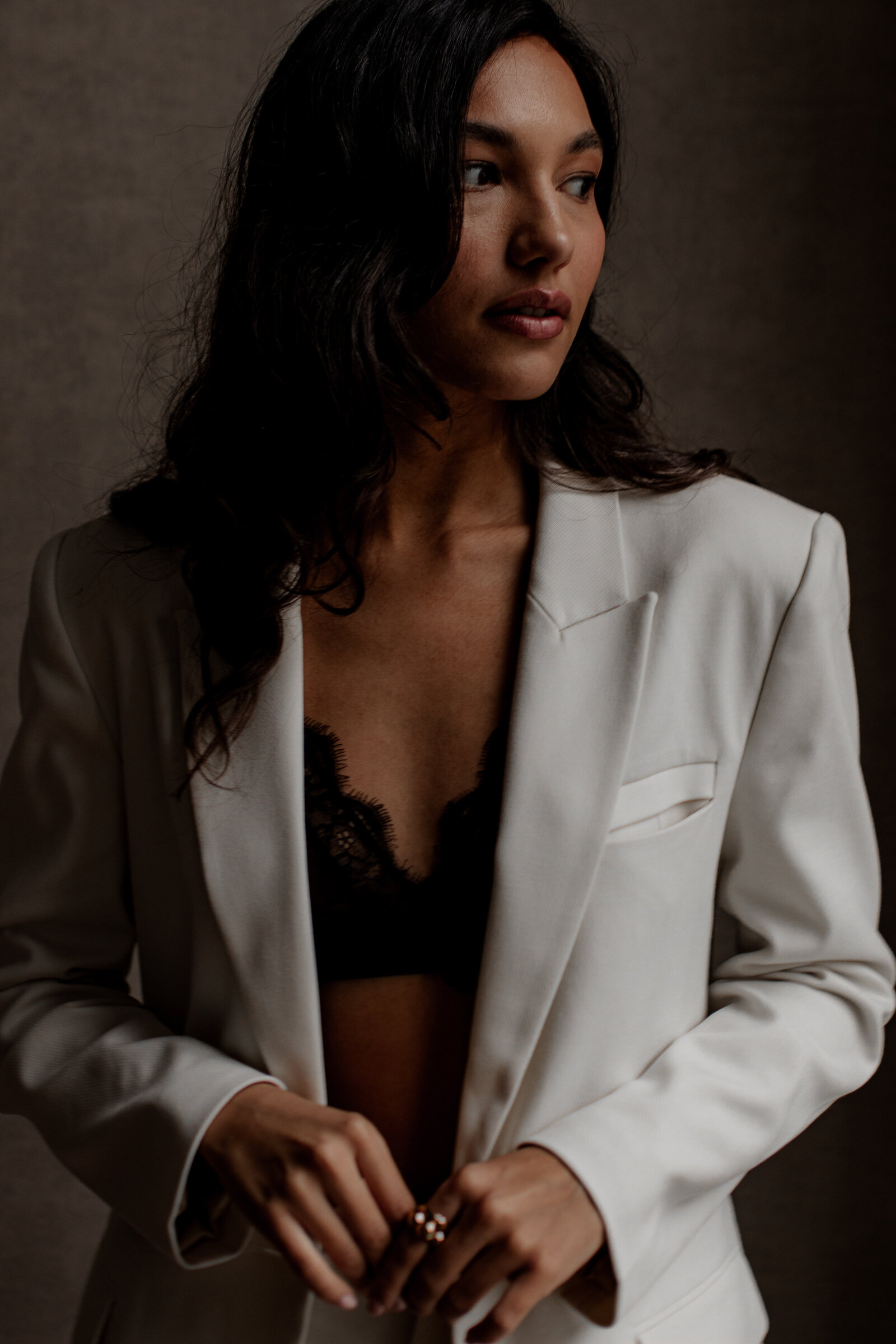Confident pose captured in a serene, artistic indoor setting