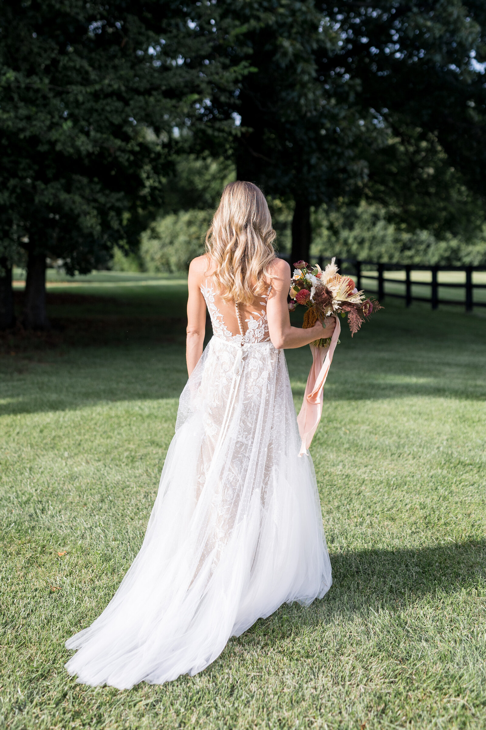 bride walking through grass