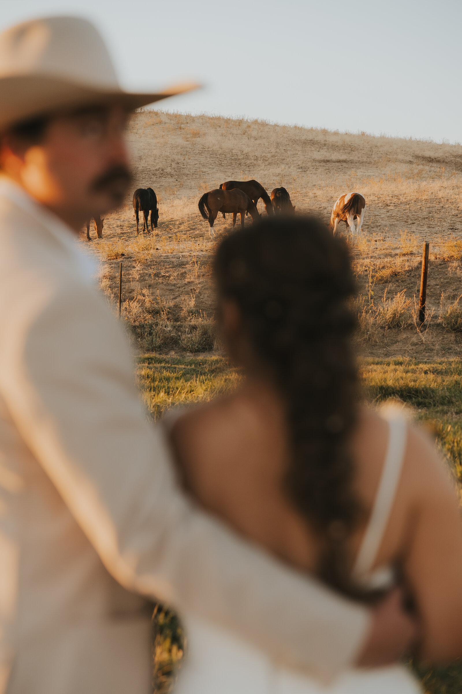 Western couple on horseback at golden hour | Idaho wedding photographer