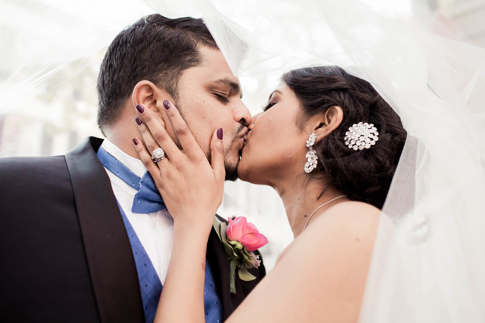 Bride and groom cuddle under the veil, French Quarter, South Carolina. Kate Timbers Photography.